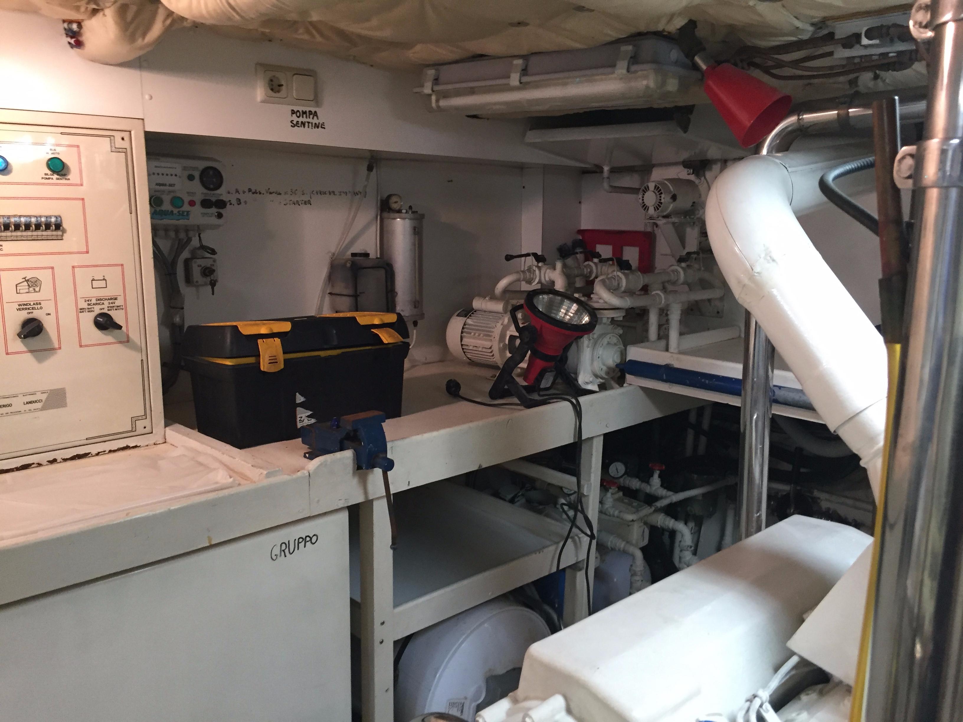 Engine room of a 1994 Falcon 76 yacht with tools and equipment.