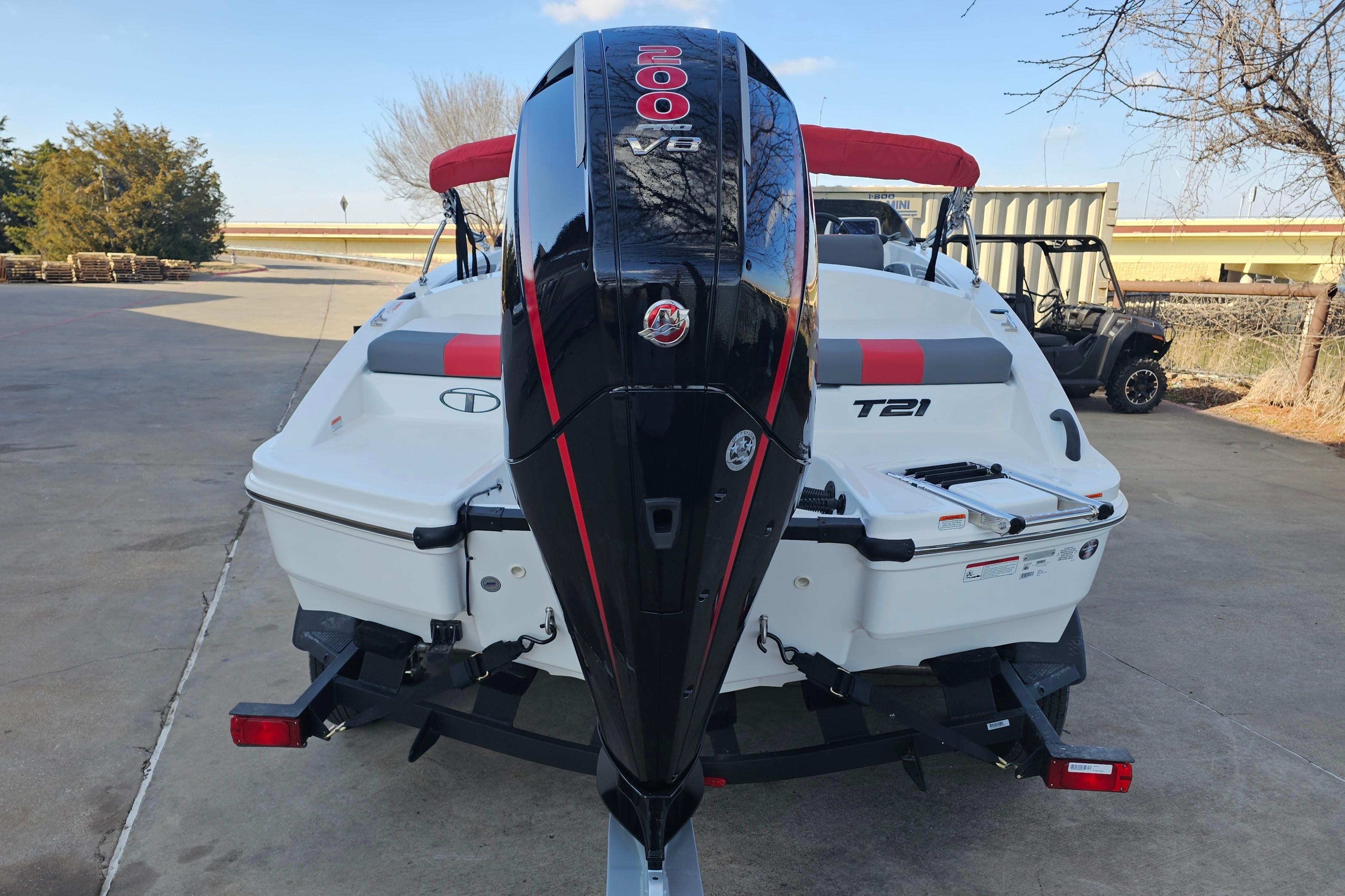 2026 Tahoe T21 boat with powerful V8 engine, parked outdoors.