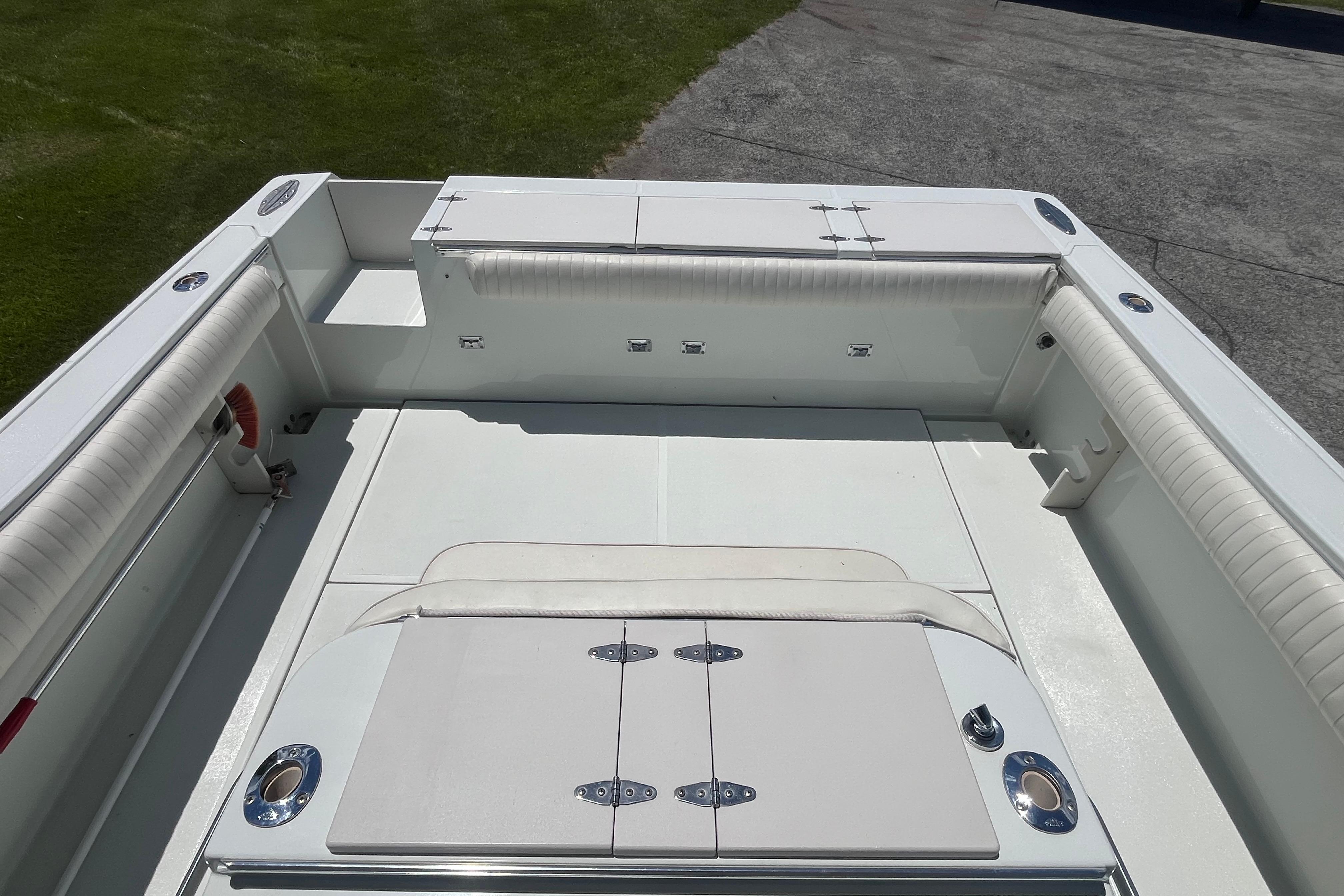 1997 Stamas boat interior with white seating and storage compartments.