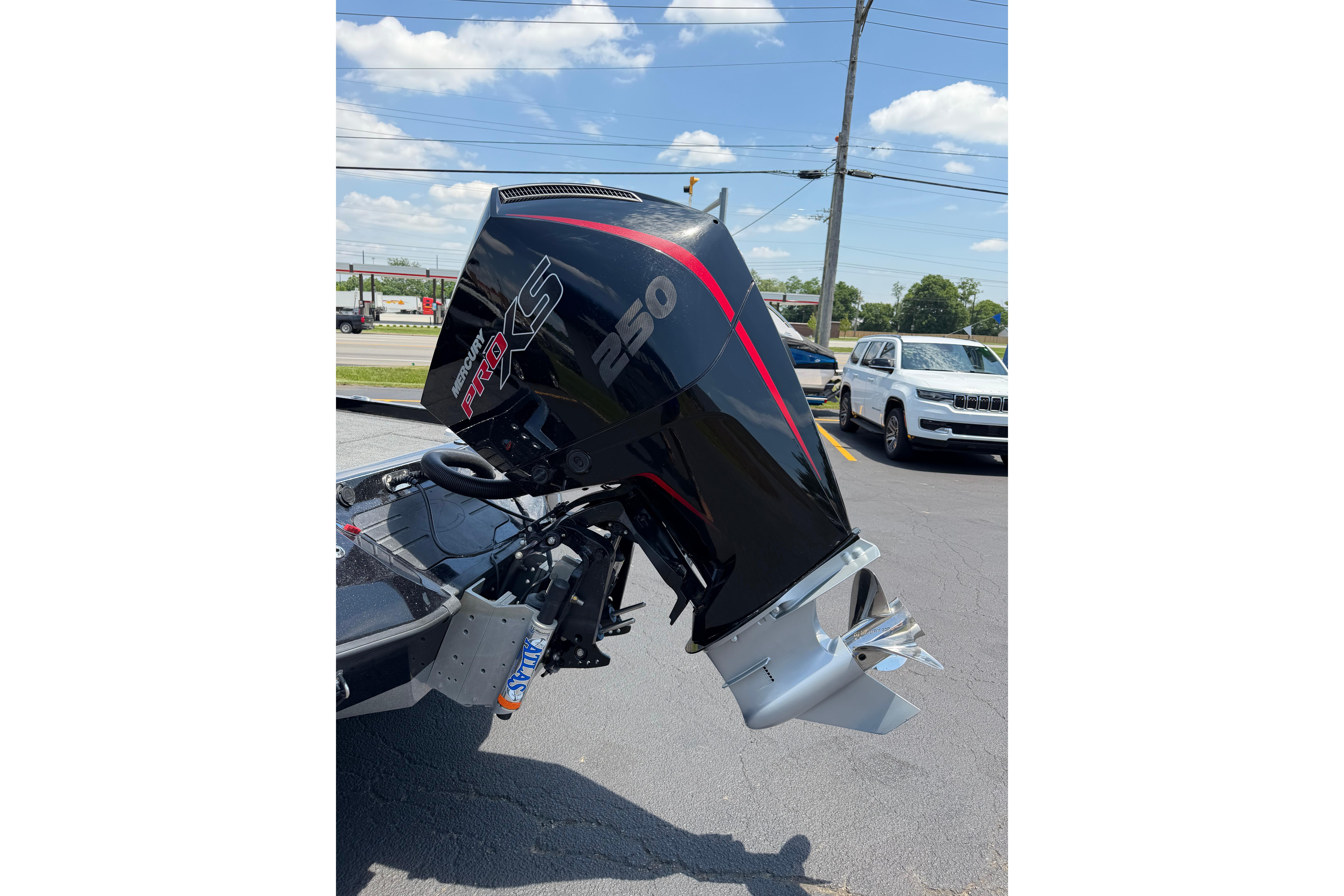 2023 Ranger Z520R boat with Mercury Pro XS 250 outboard motor in parking lot.