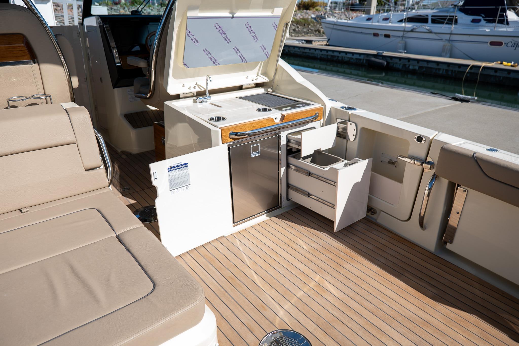 2024 Chris-Craft Calypso 32 boat interior with kitchenette and seating area.
