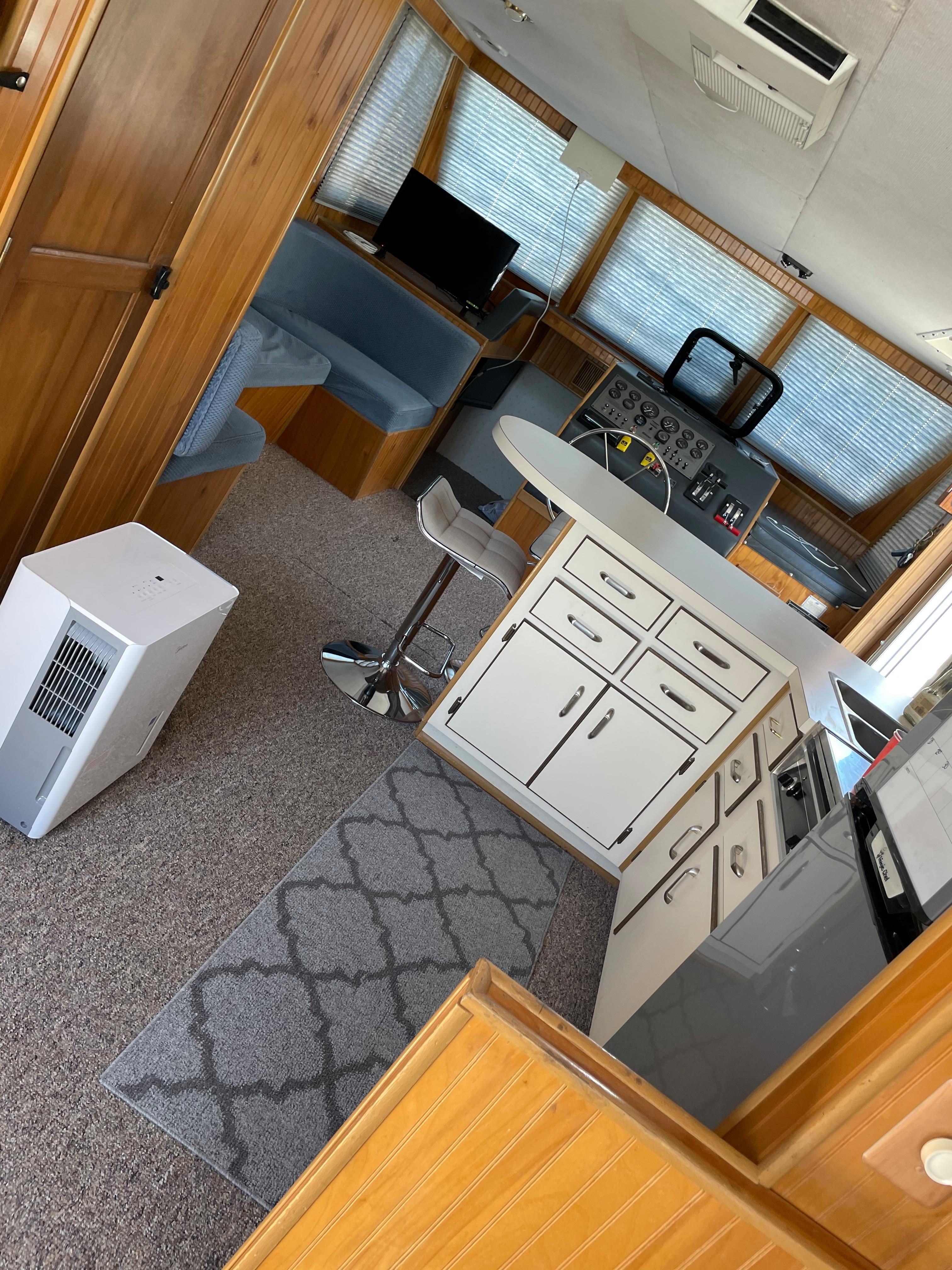 Interior of a 1993 Gibson Sport Series with kitchen and helm station.