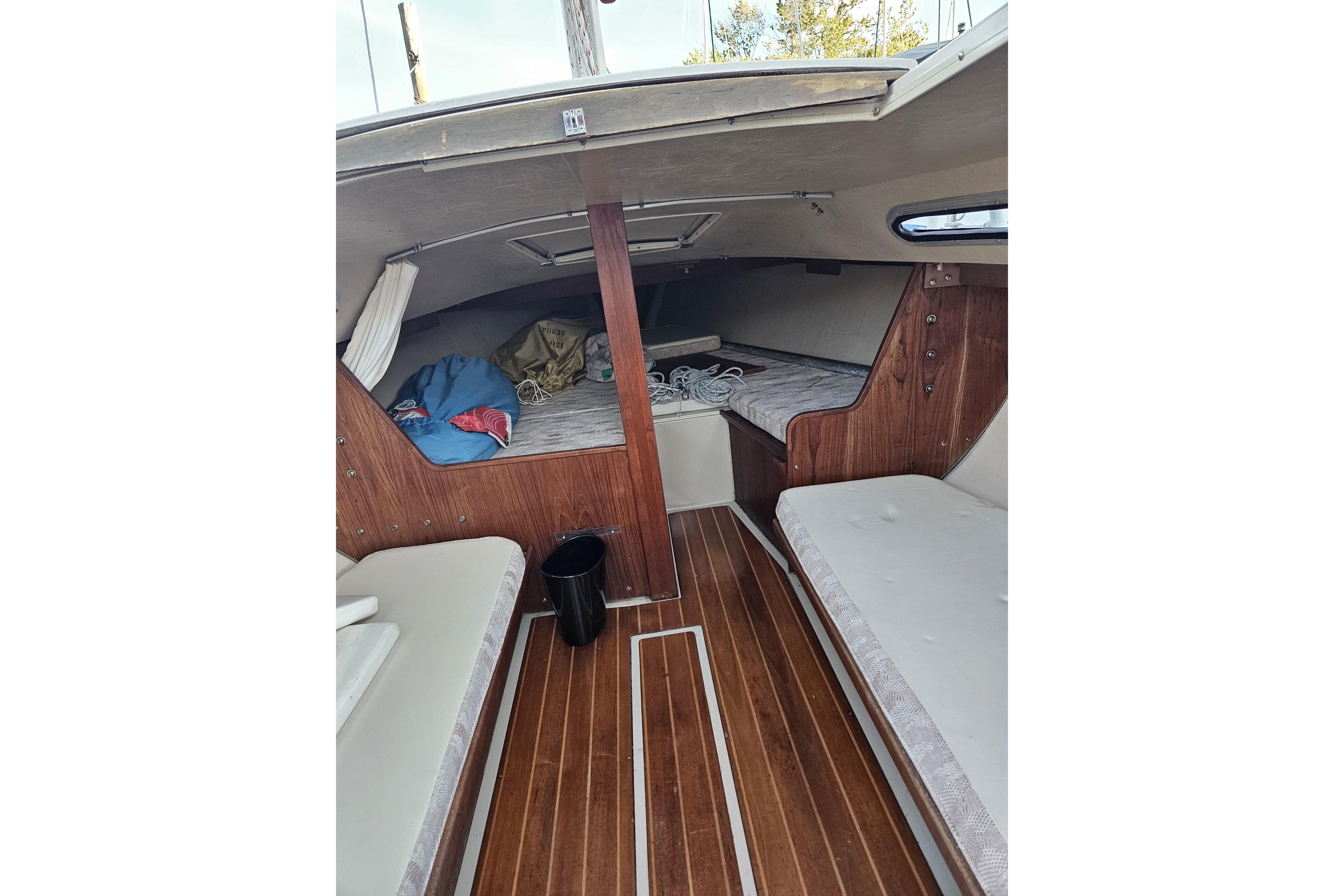 Interior of 1981 Catalina Capri 25 sailboat with wooden flooring and cozy cabin space.