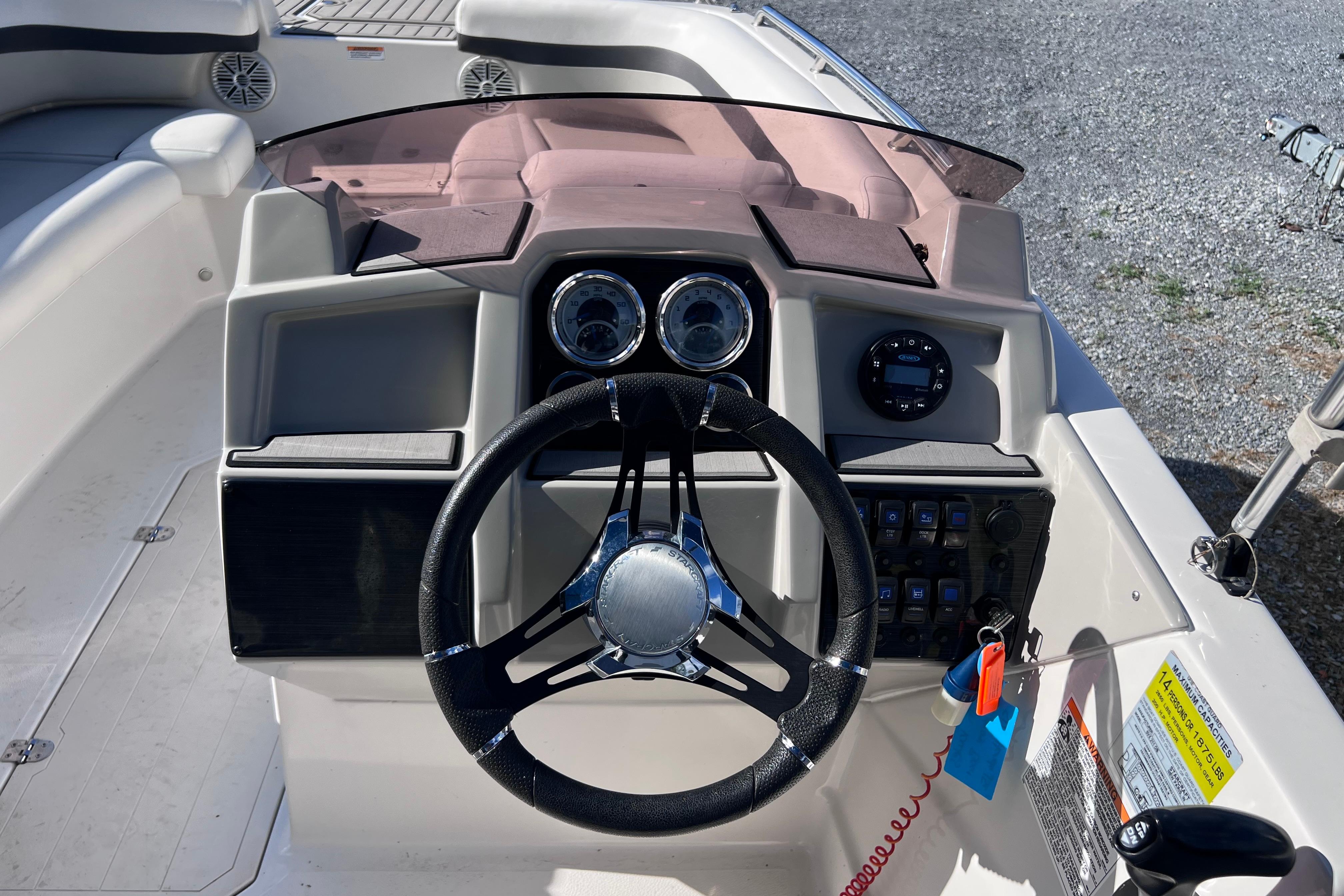 2021 Starcraft SVX 211 OB boat dashboard with steering wheel and control panel.