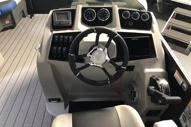 2026 SunChaser Geneva Sport 21 SB DH boat dashboard with steering wheel and control panel.