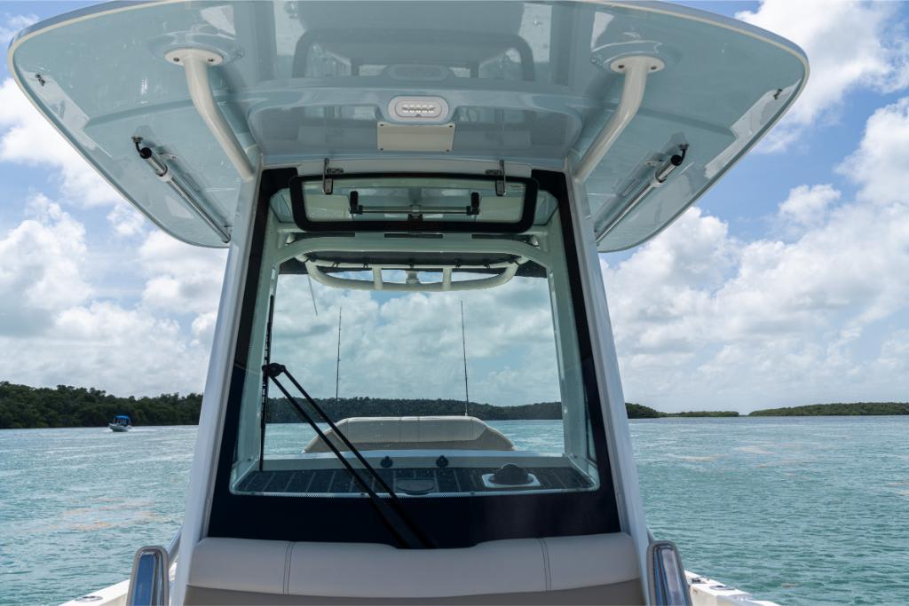 2024 Boston Whaler 280 Dauntless boat on calm waters with clear sky.