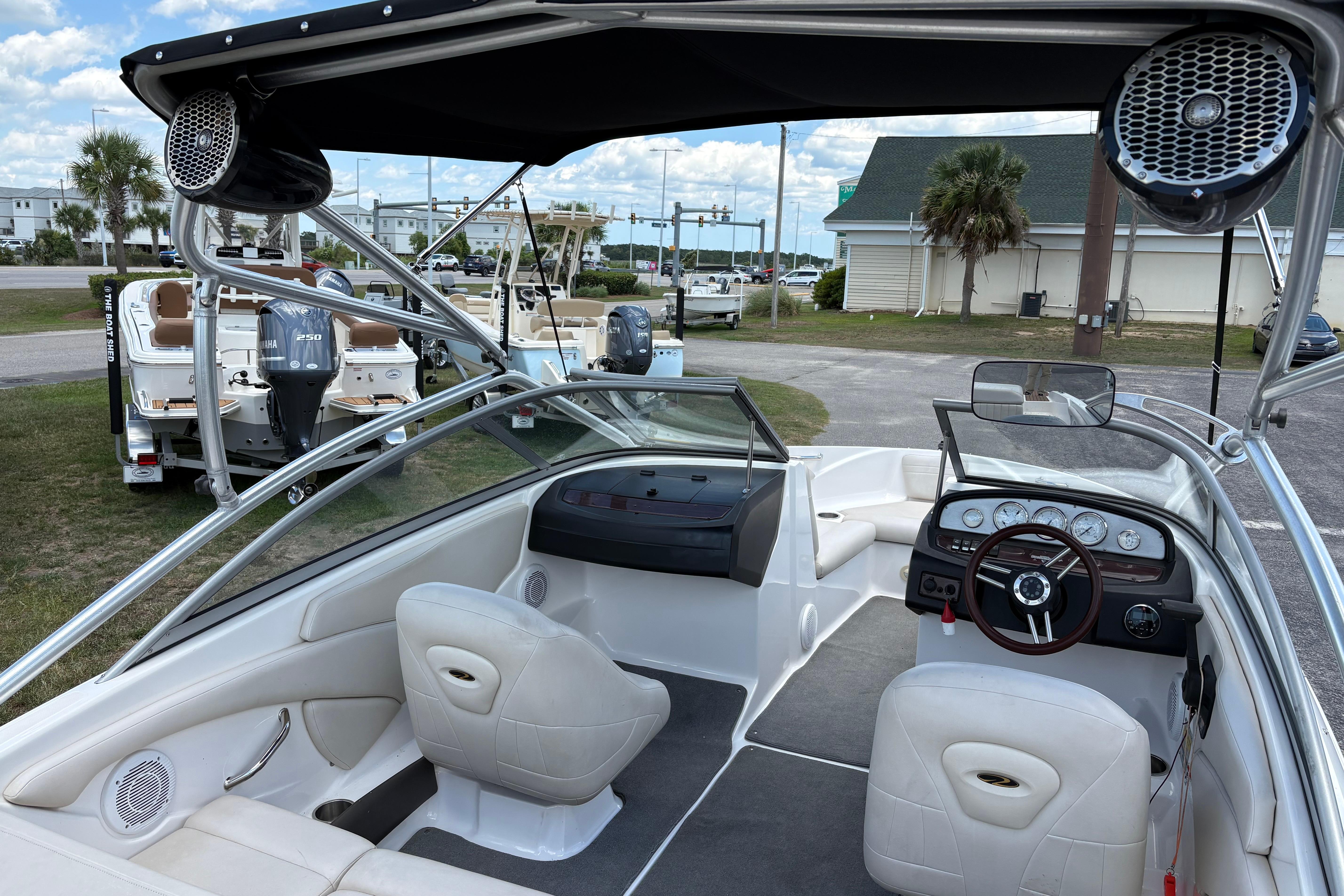 2008 Regal 1900 Bowrider boat interior with steering wheel, seating, and speakers.
