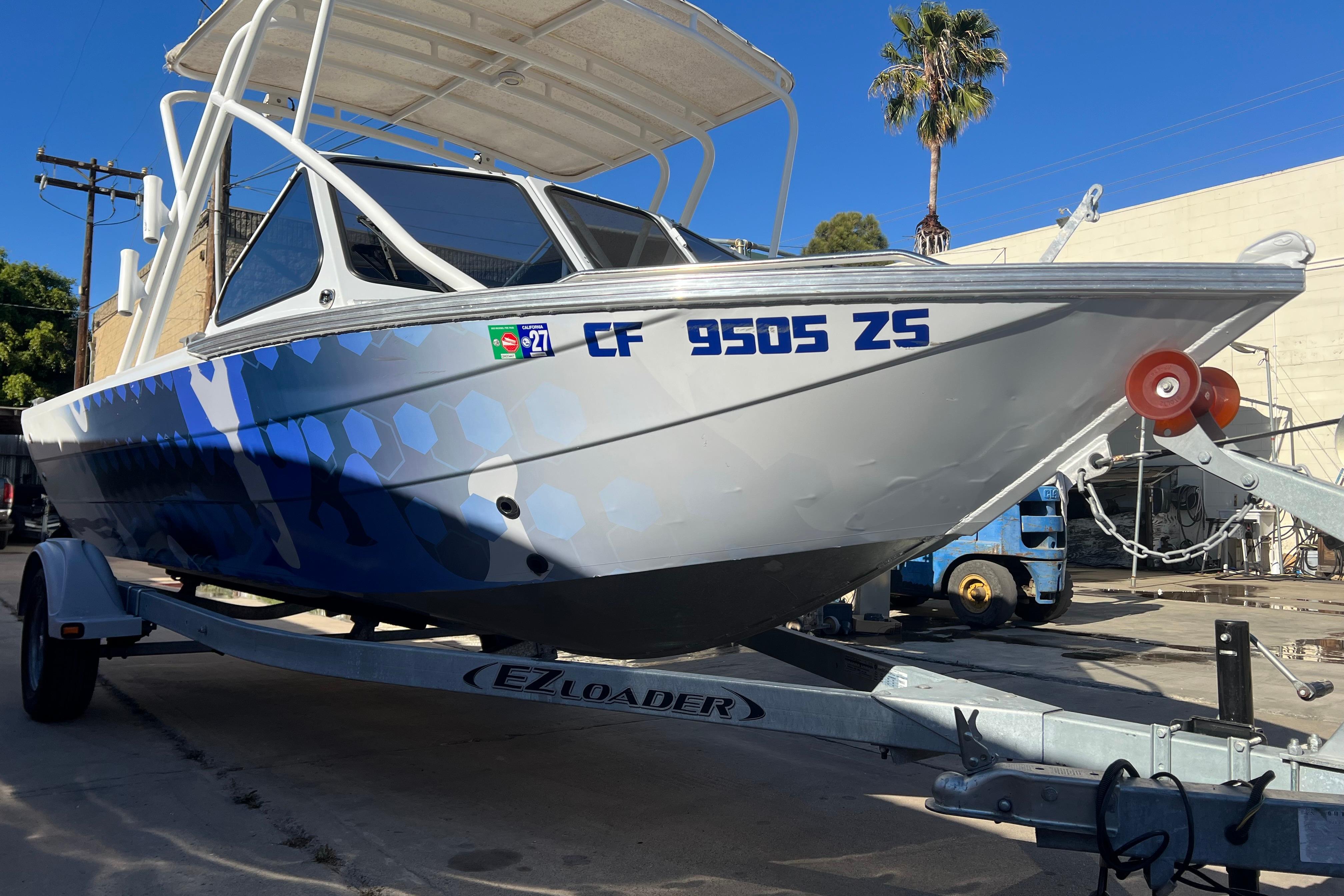 2019 KingFisher 1825 Falcon boat on trailer, parked outdoors.