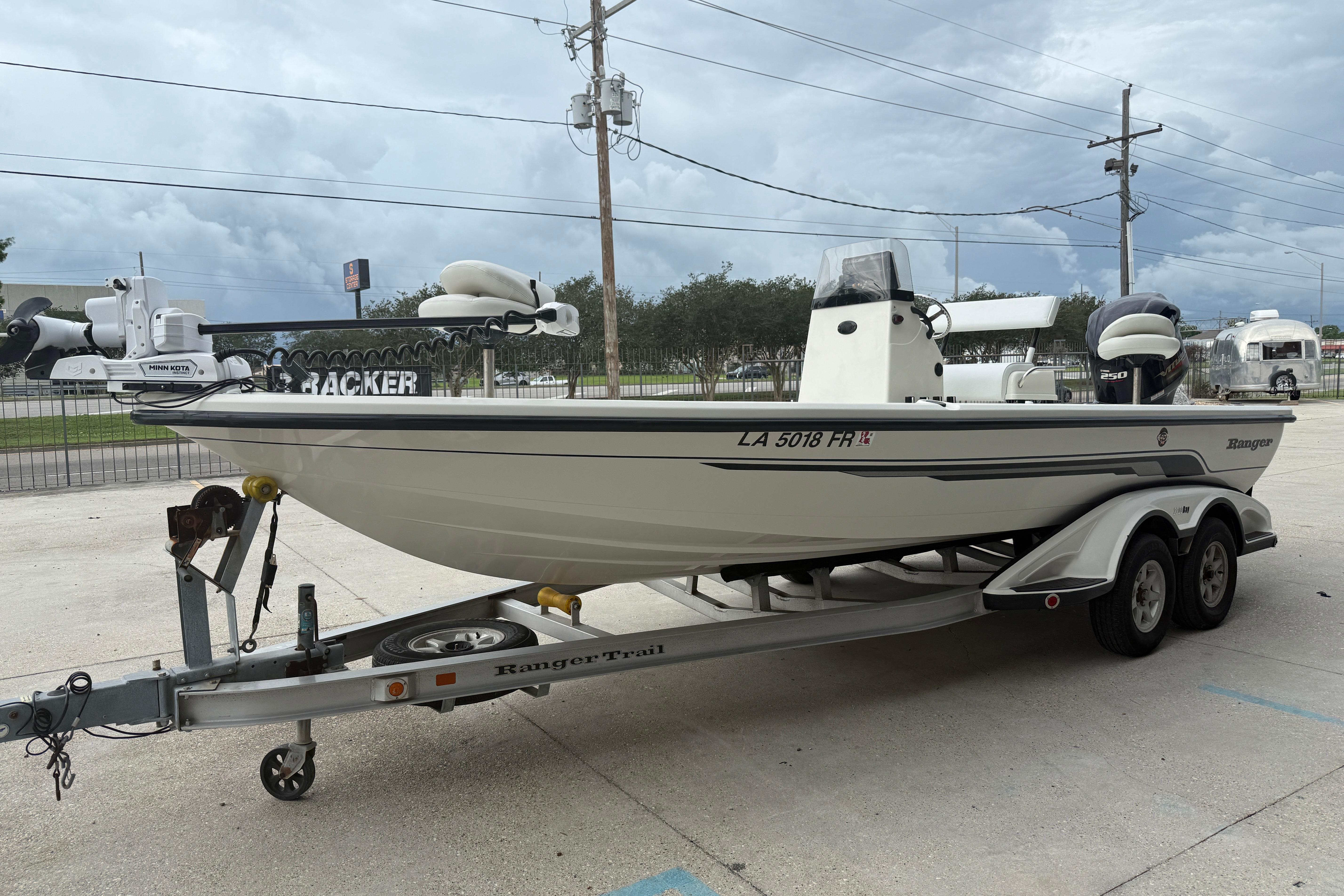2007 Ranger 2200 Bay Ranger boat on trailer, parked outdoors under cloudy sky.