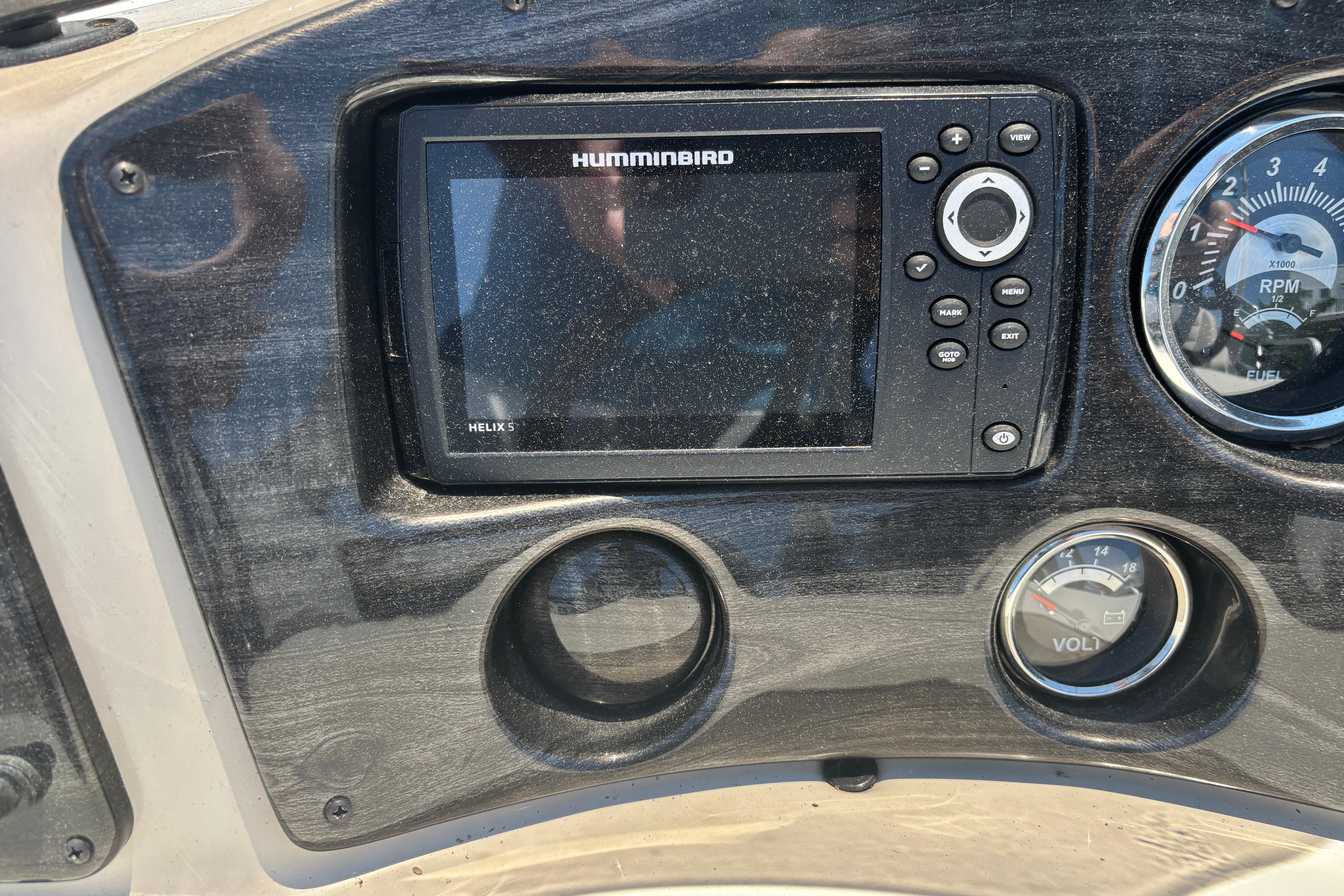 Dashboard of a 2017 Qwest LS 822 Bar with Humminbird Helix 5 display and gauges.