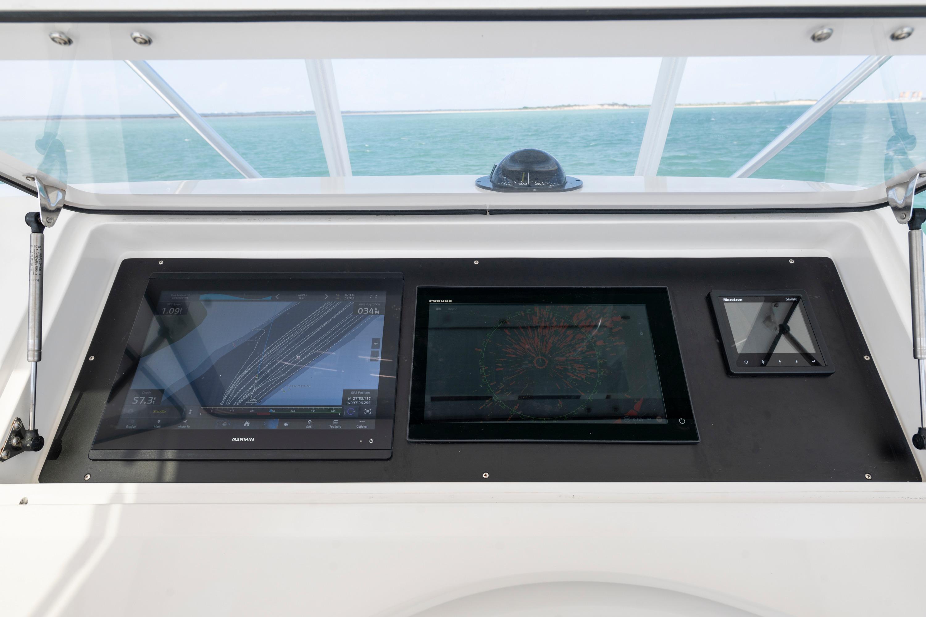 Control panel of a 2009 Viking 50 Convertible yacht with navigation displays.