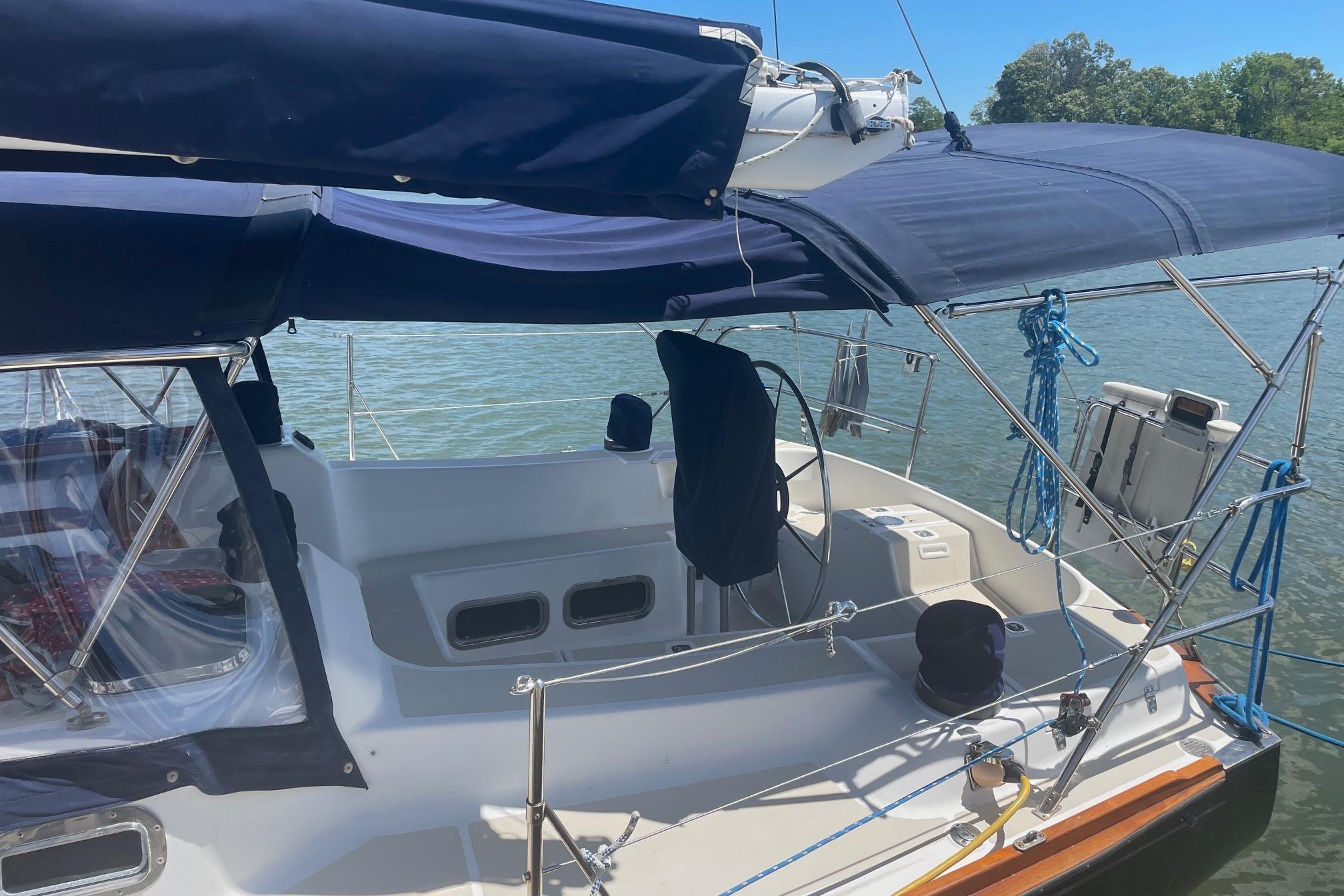 2001 Tartan 3700 sailboat with blue canopy, docked on a sunny day.