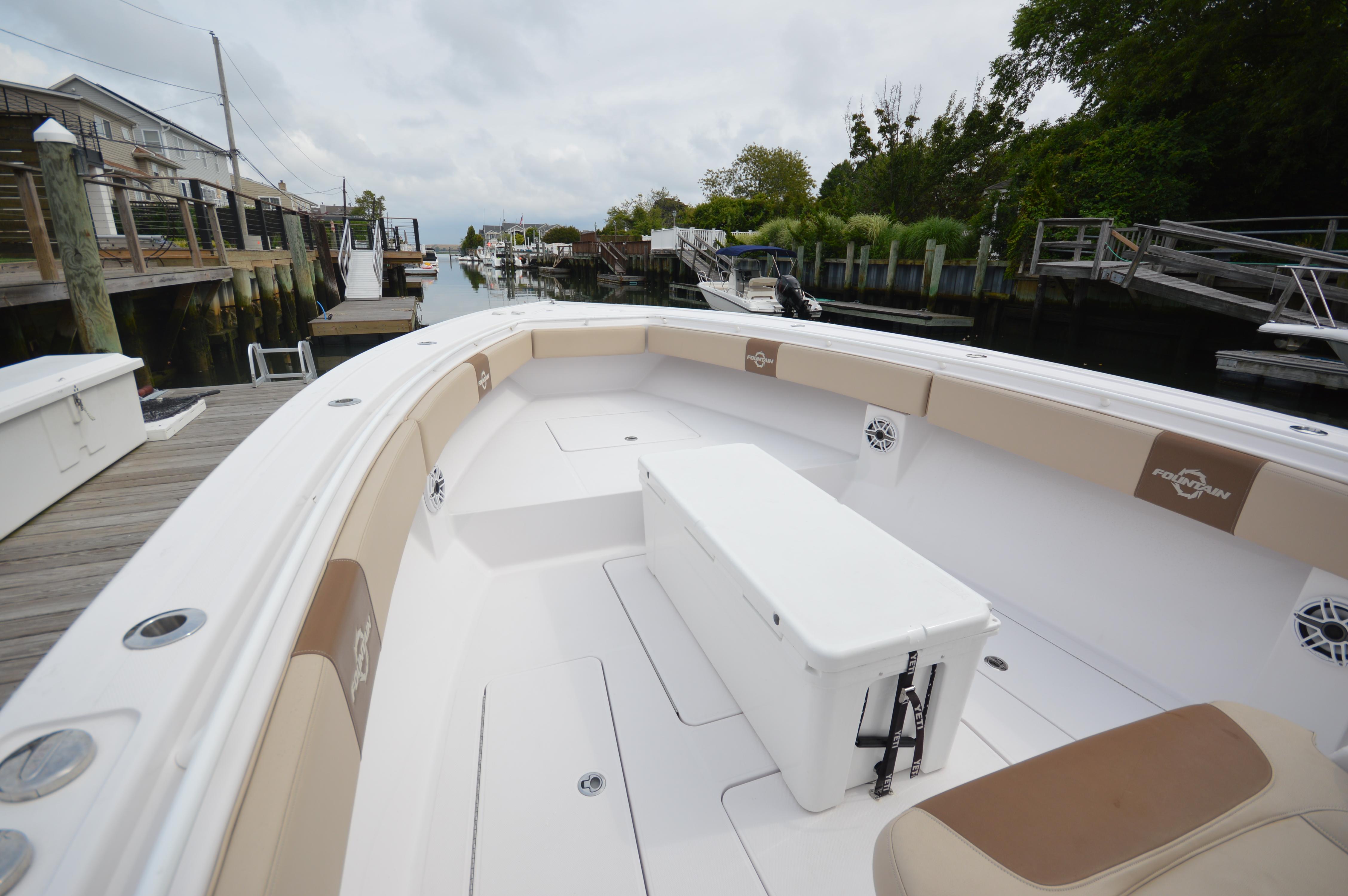2017 Fountain 38 Center Console boat docked at a marina, featuring spacious seating and storage.