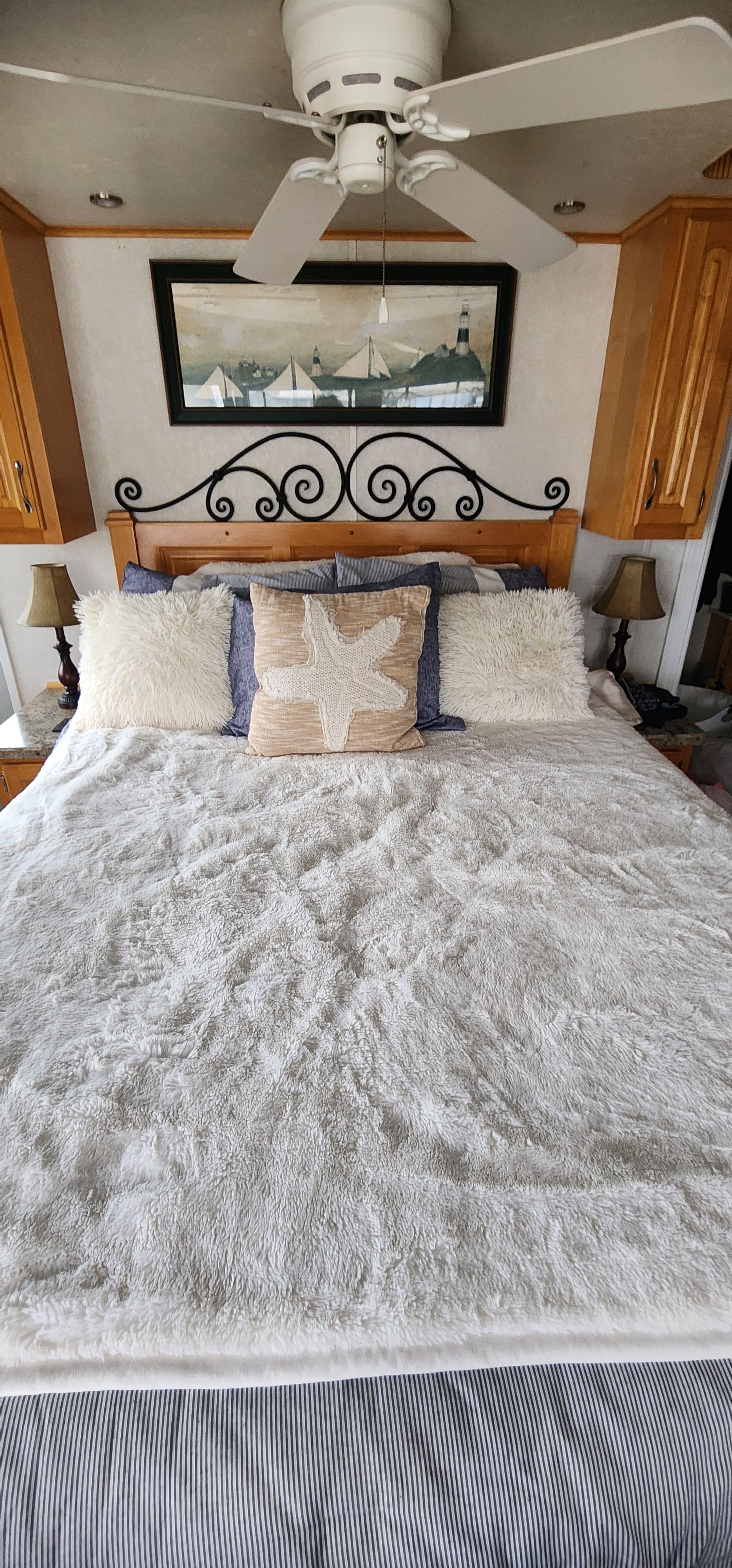 A cozy bedroom with a large bed and decorative pillows.
