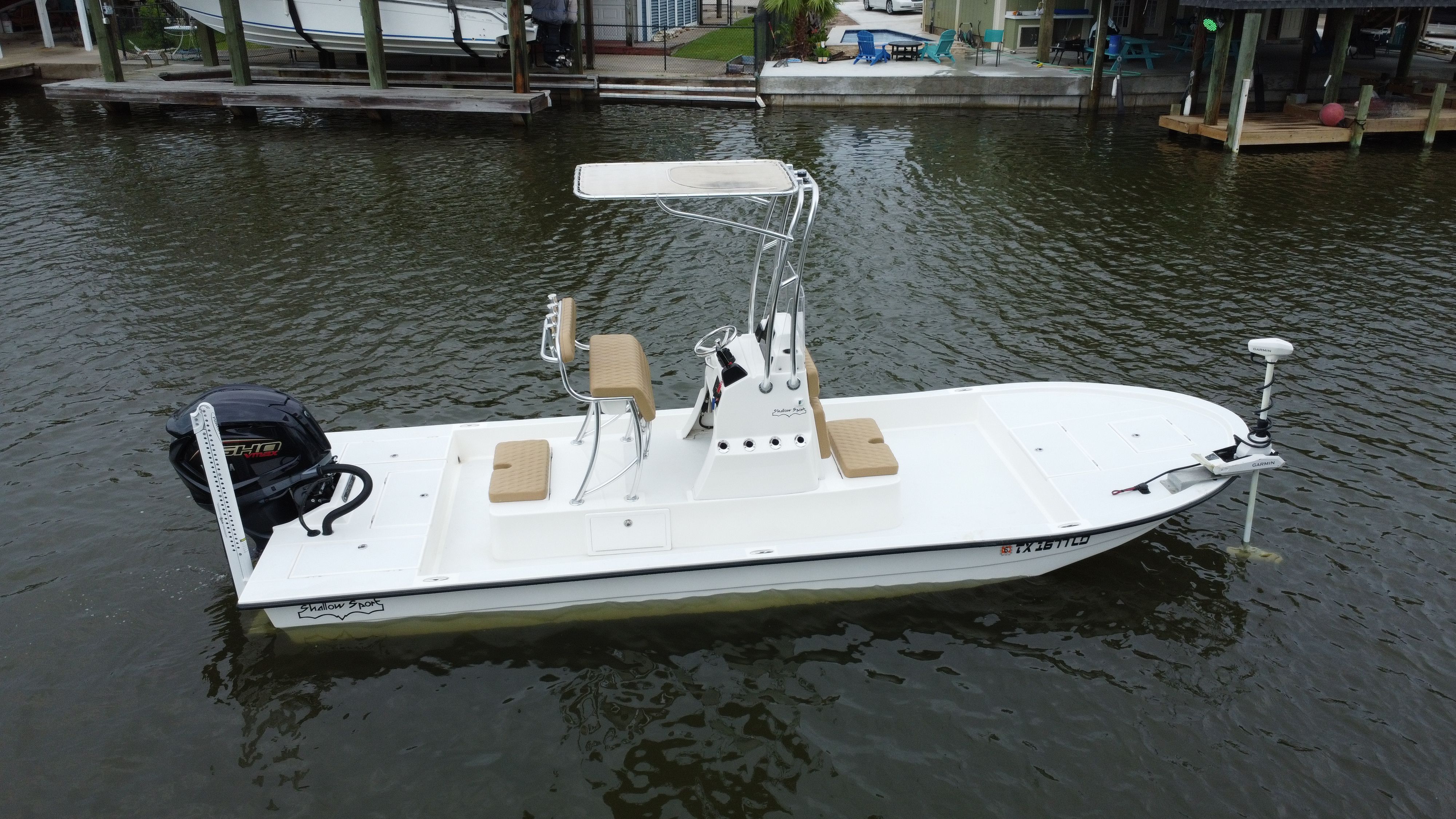 A 2025 Shallow Sport 24 Sport boat is docked on the water.