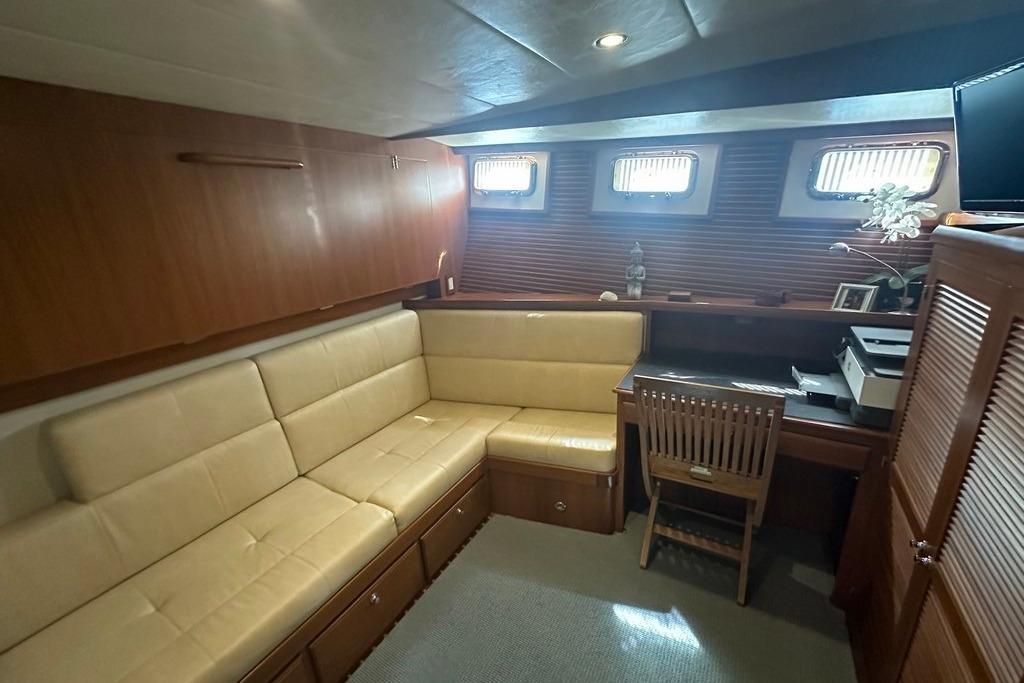 Luxurious interior of 2011 Kadey-Krogen 48 AE yacht with beige seating and wooden desk.