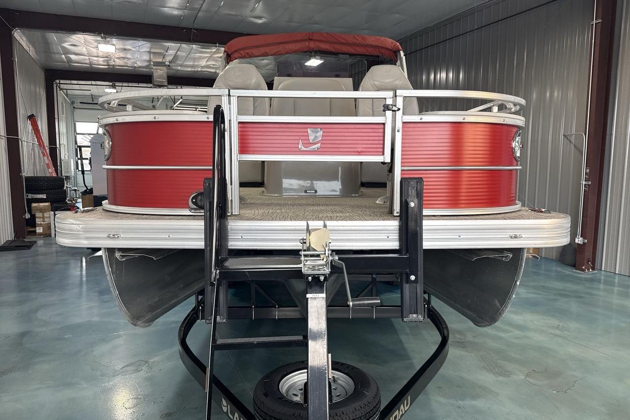 2022 Landau ALURE 232 pontoon boat in a garage, featuring a red exterior.
