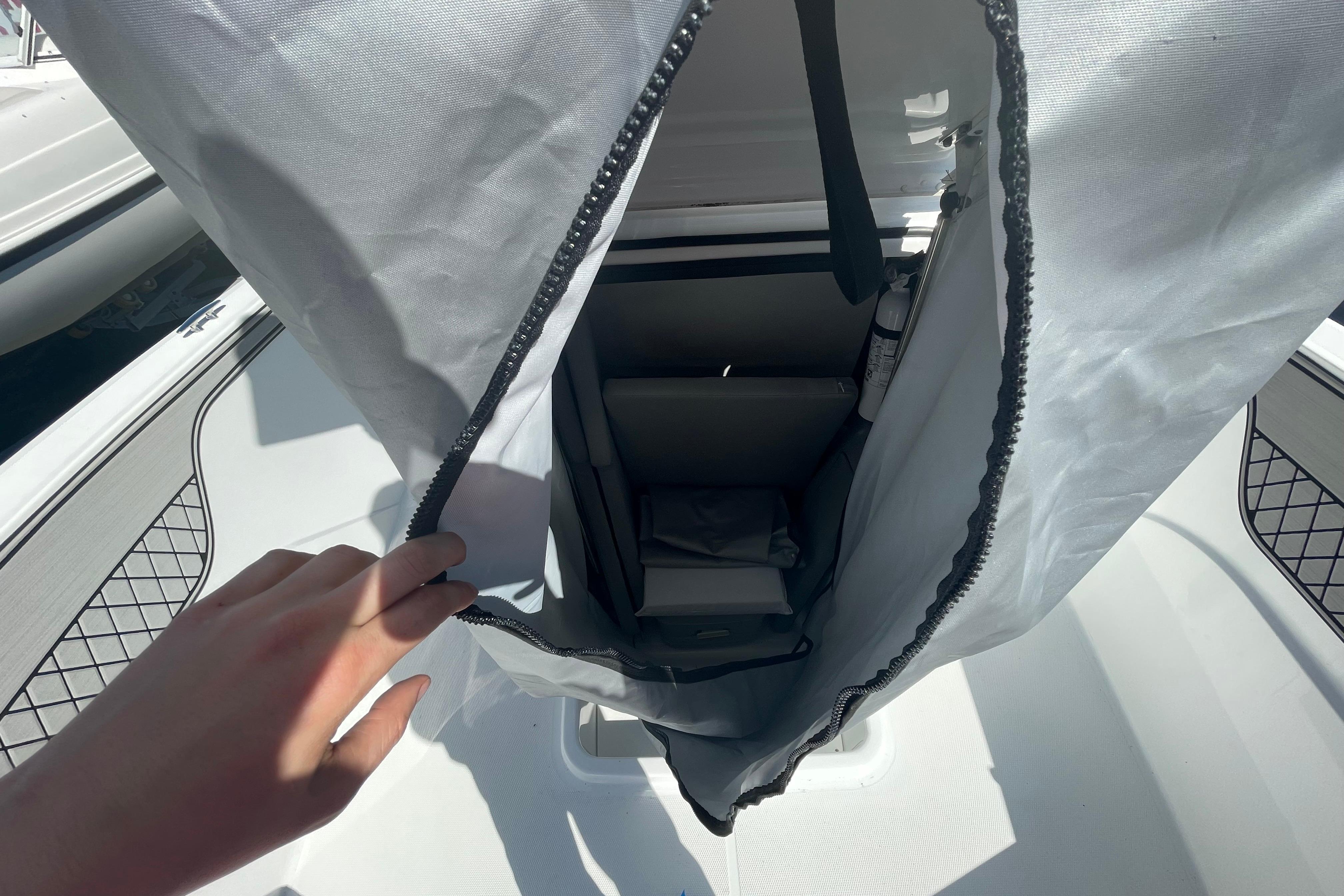 2022 Wellcraft 202 Fisherman boat interior with storage compartment and safety equipment.