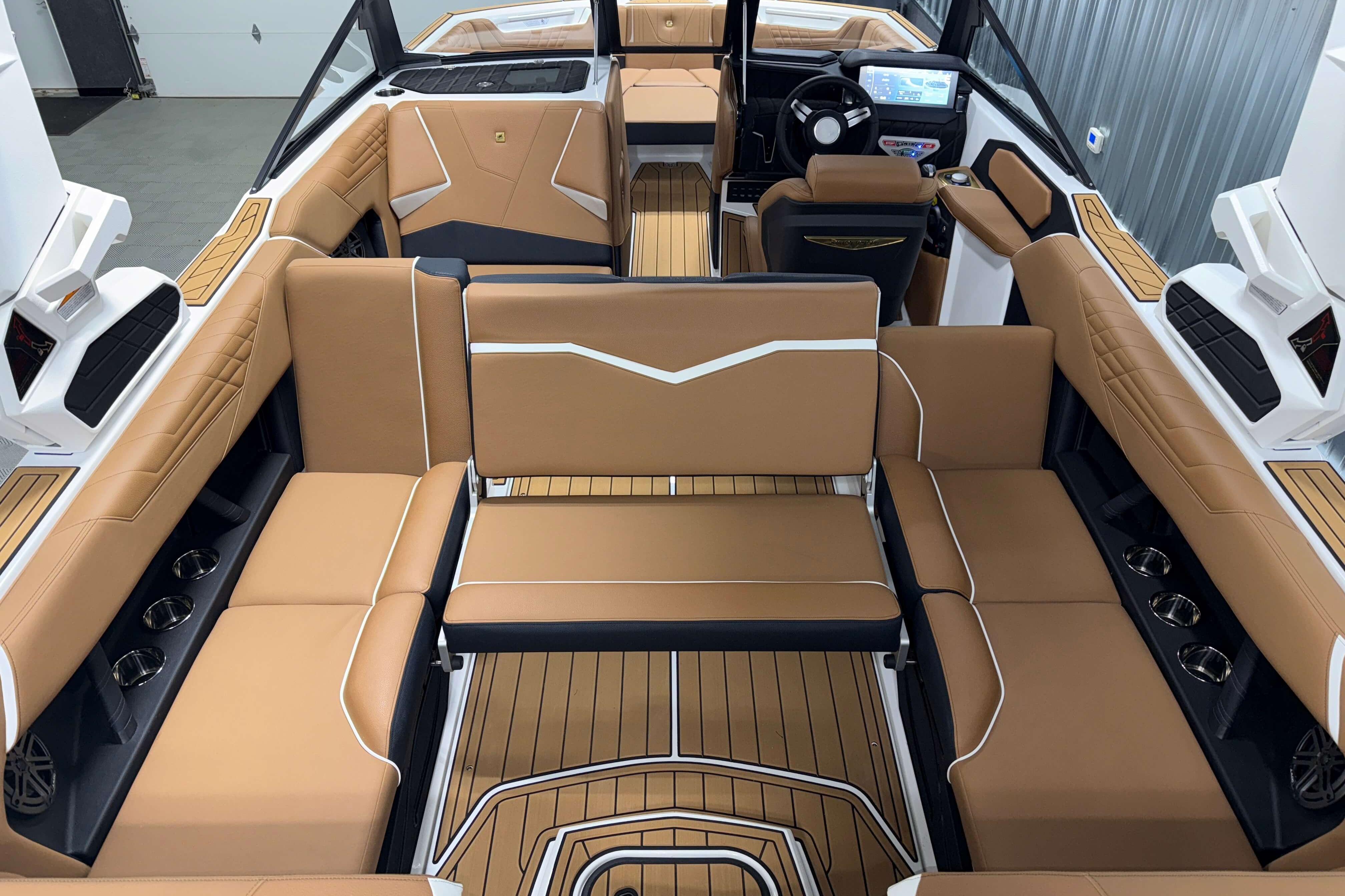 Luxurious interior of 2026 Nautique Super Air Nautique S23 with tan seating and modern dashboard.