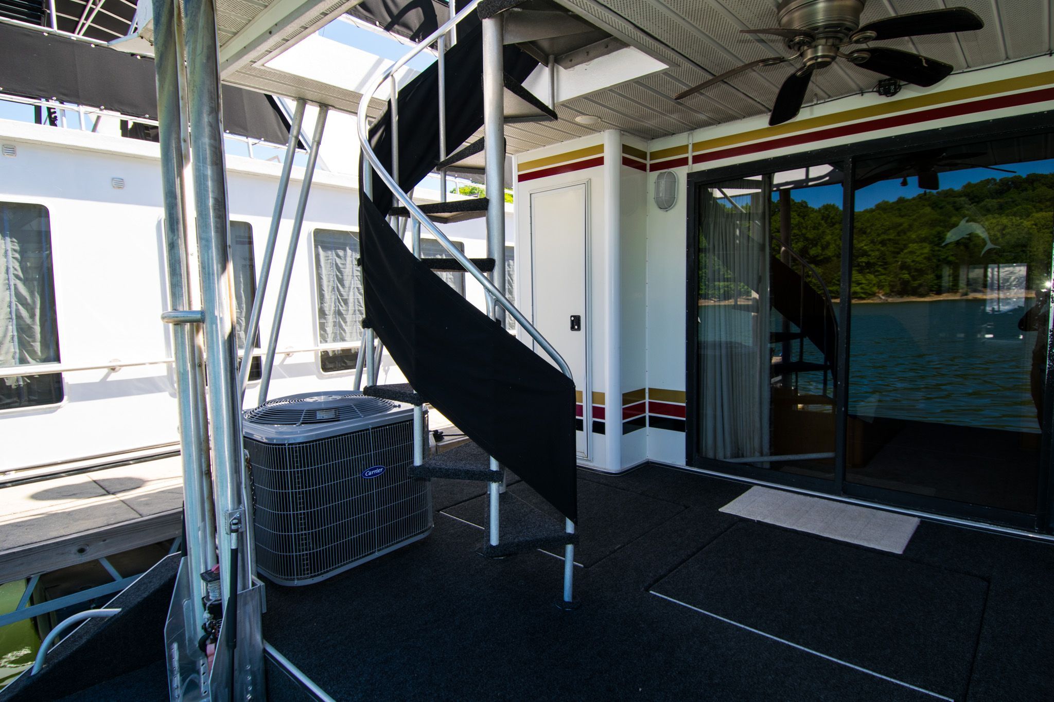 2003 Lakeview 16x70 houseboat with spiral staircase and deck.