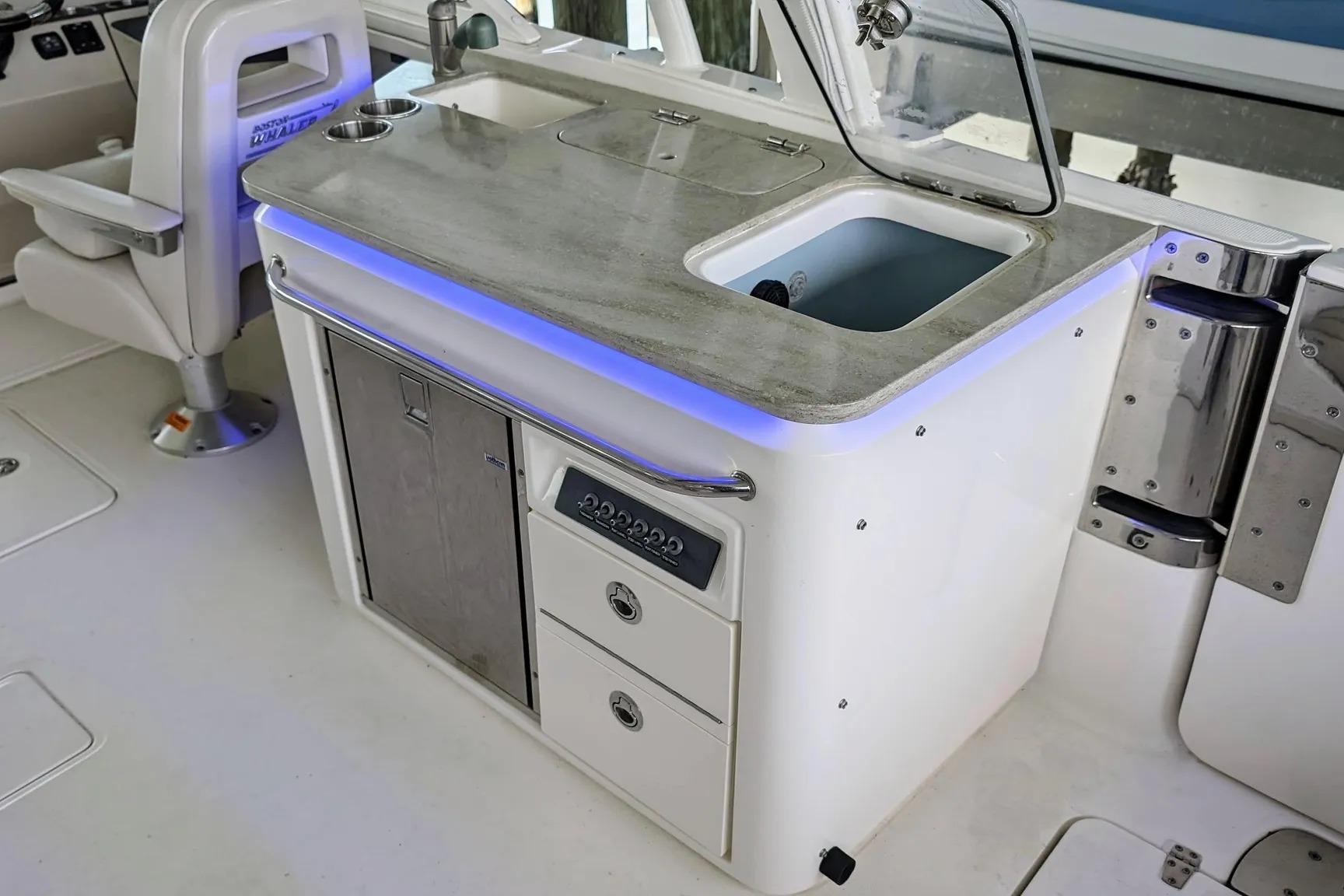 2017 Boston Whaler 320 Vantage boat interior with sink and storage area.