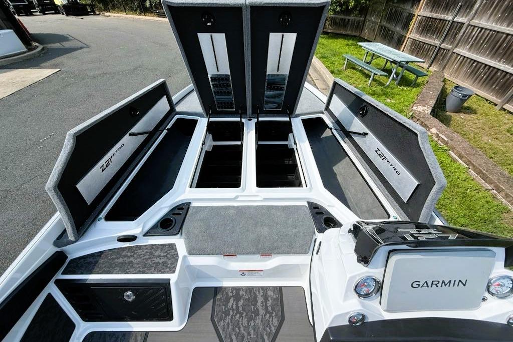 2025 Nitro Z21 XL Pro boat interior with open storage compartments and Garmin electronics.