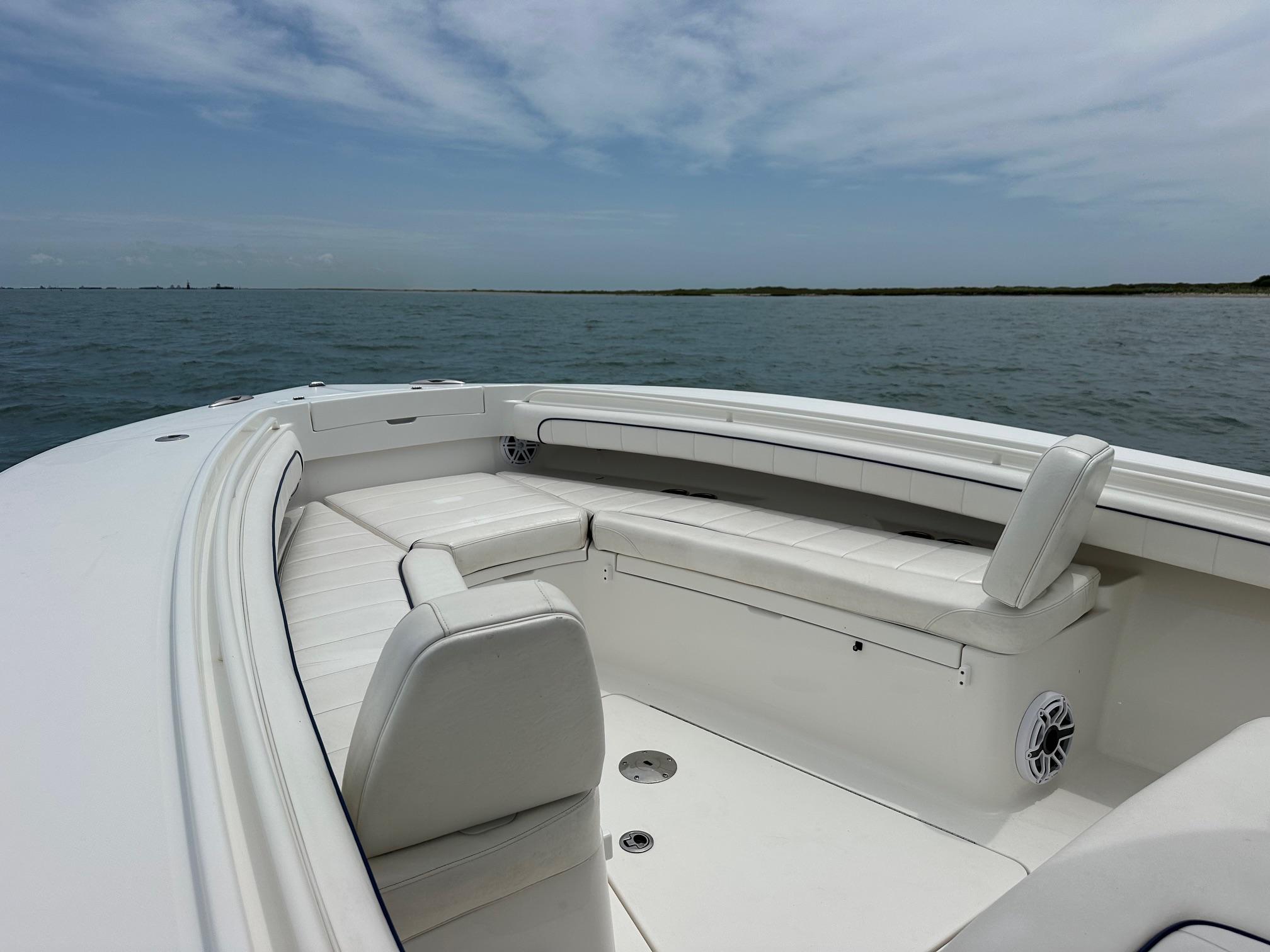 2016 Regulator Center Console boat with white seating, on calm ocean waters.