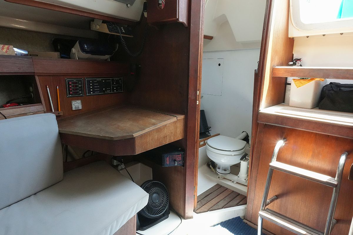 Interior of a 1985 Hunter 28.5 yacht with toilet and wooden furnishings.