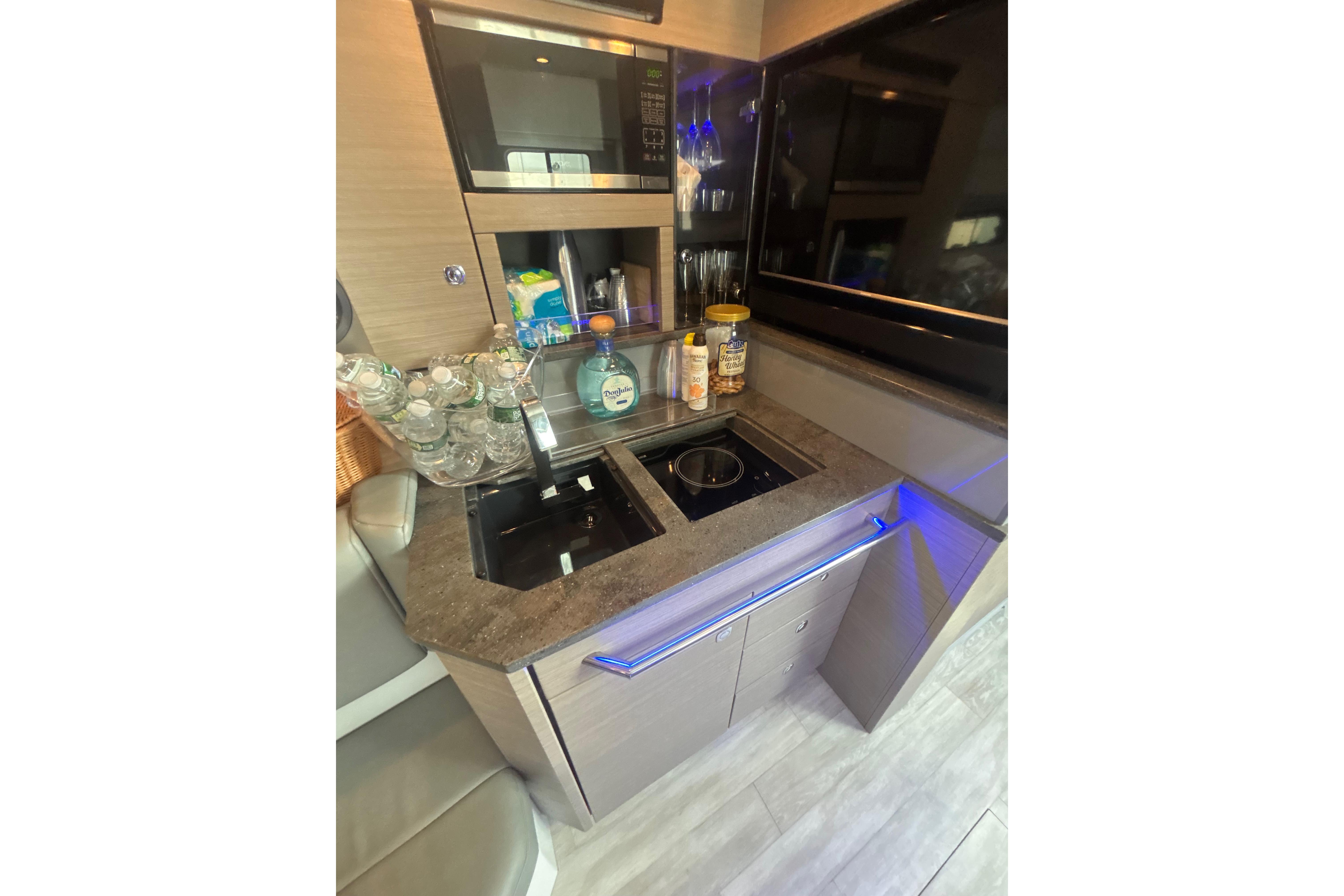 Compact kitchen area in a 2019 Formula 430 Super Sport Crossover boat.