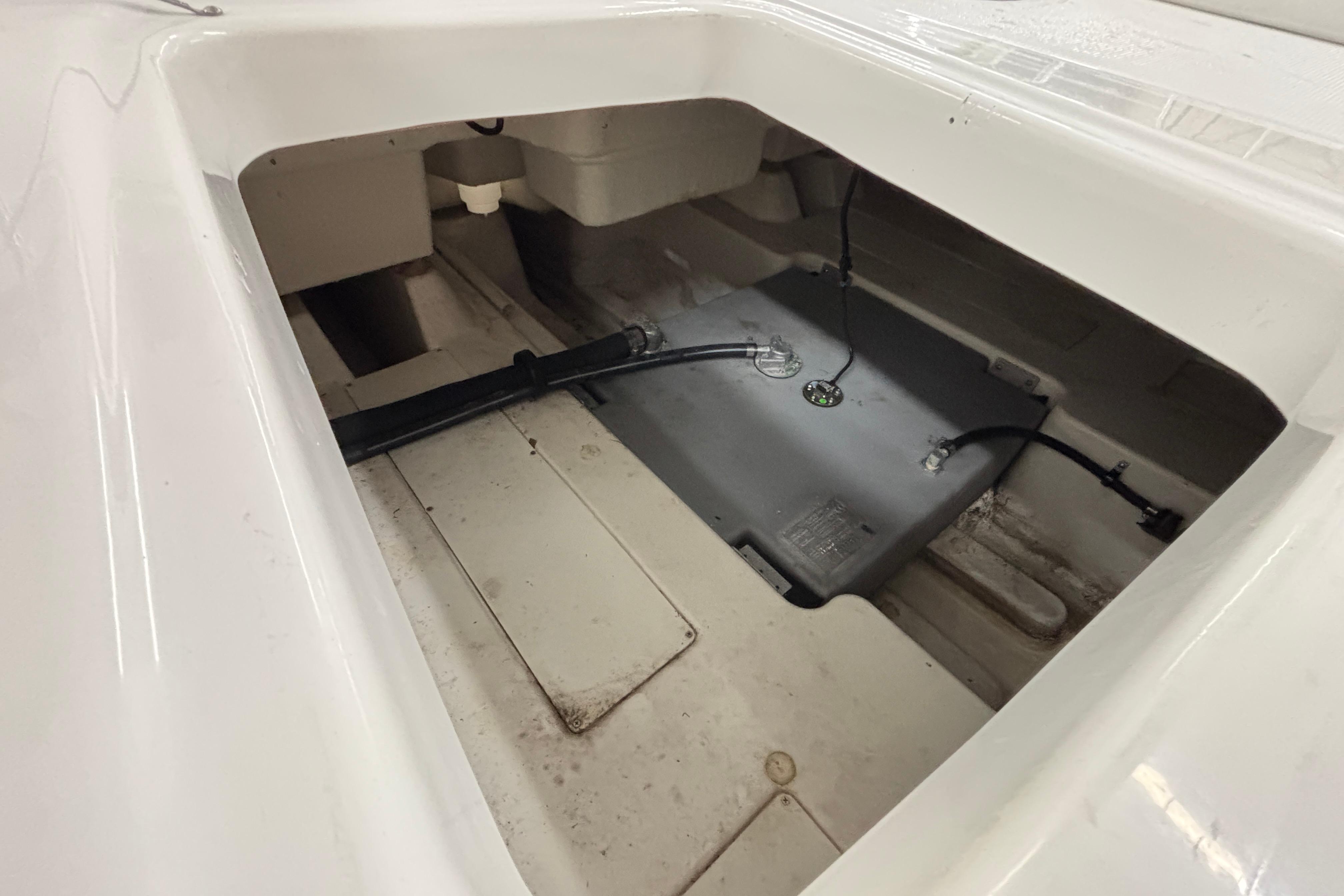 2024 Tahoe T18 boat interior storage compartment with visible wiring and components.