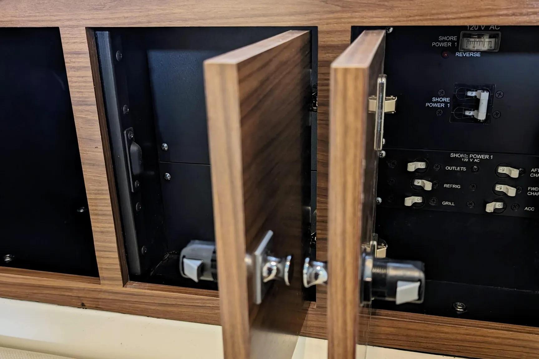 Electrical panel inside 2017 Boston Whaler 320 Vantage boat, featuring switches and circuit breakers.