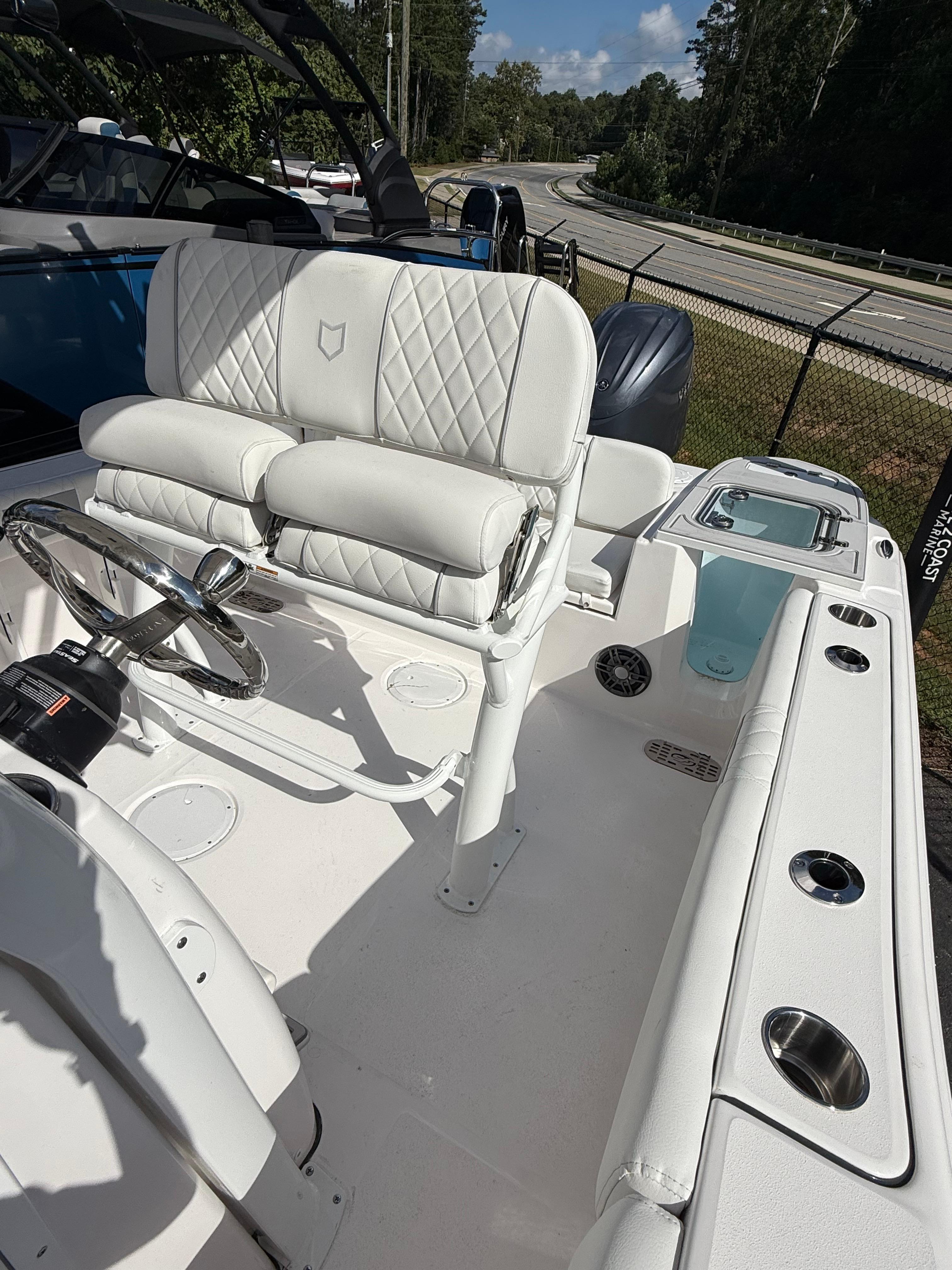 2026 Sea Fox 228 Commander boat interior with white seating and steering wheel.