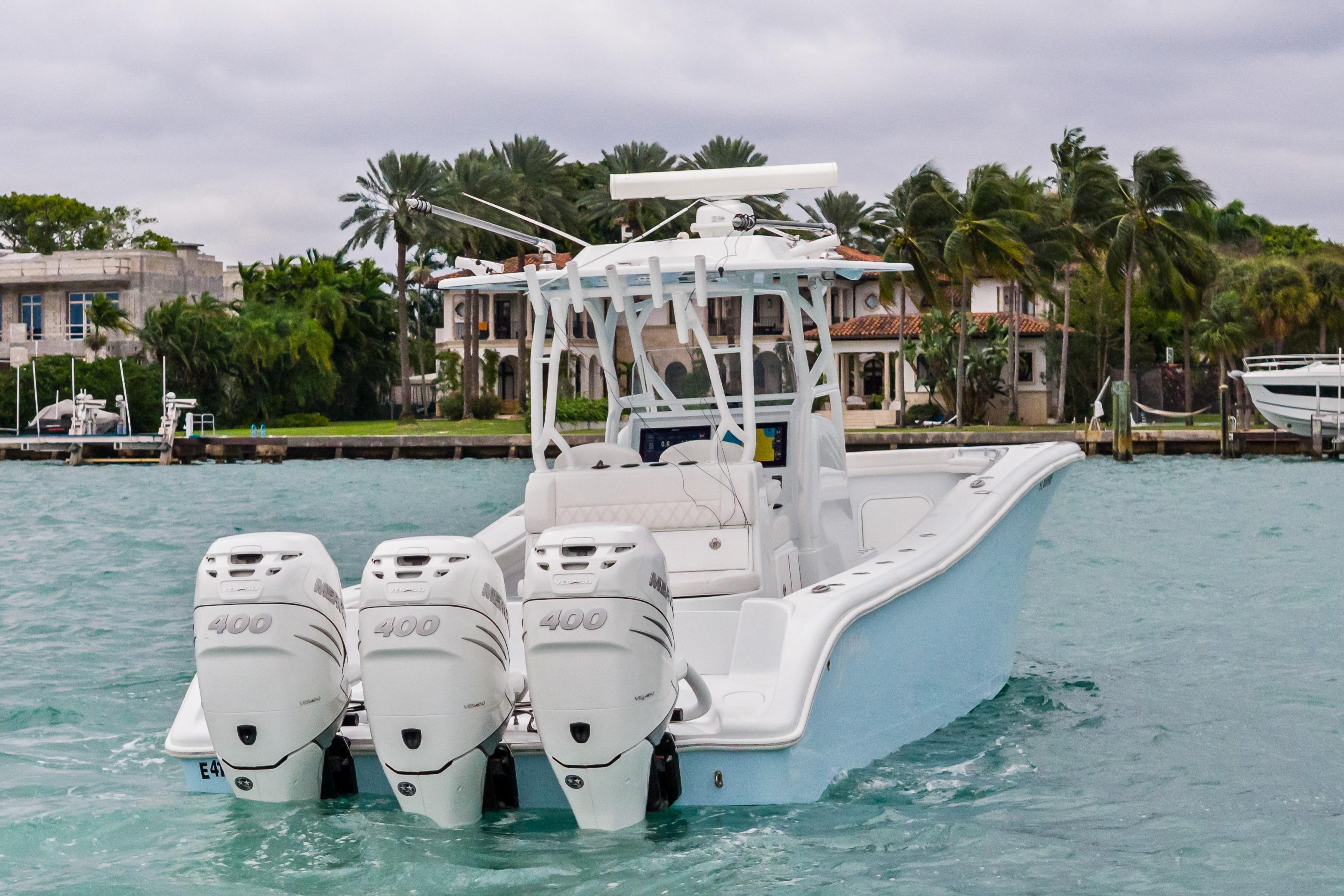 2021 Yellowfin 36 Offshore boat with triple engines on turquoise water.