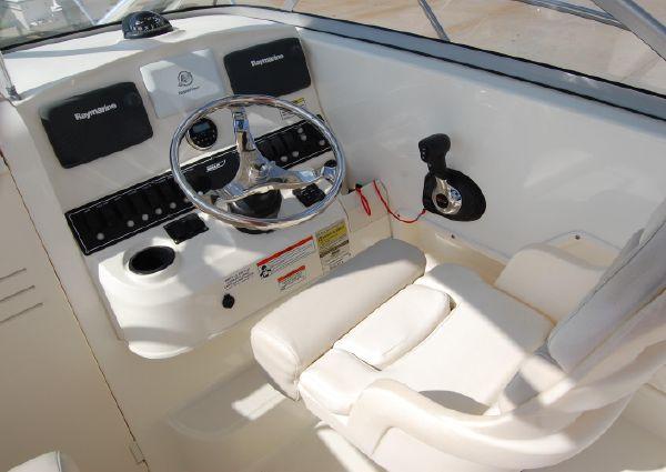 2011 Boston Whaler 235 Conquest boat helm with steering wheel and controls.