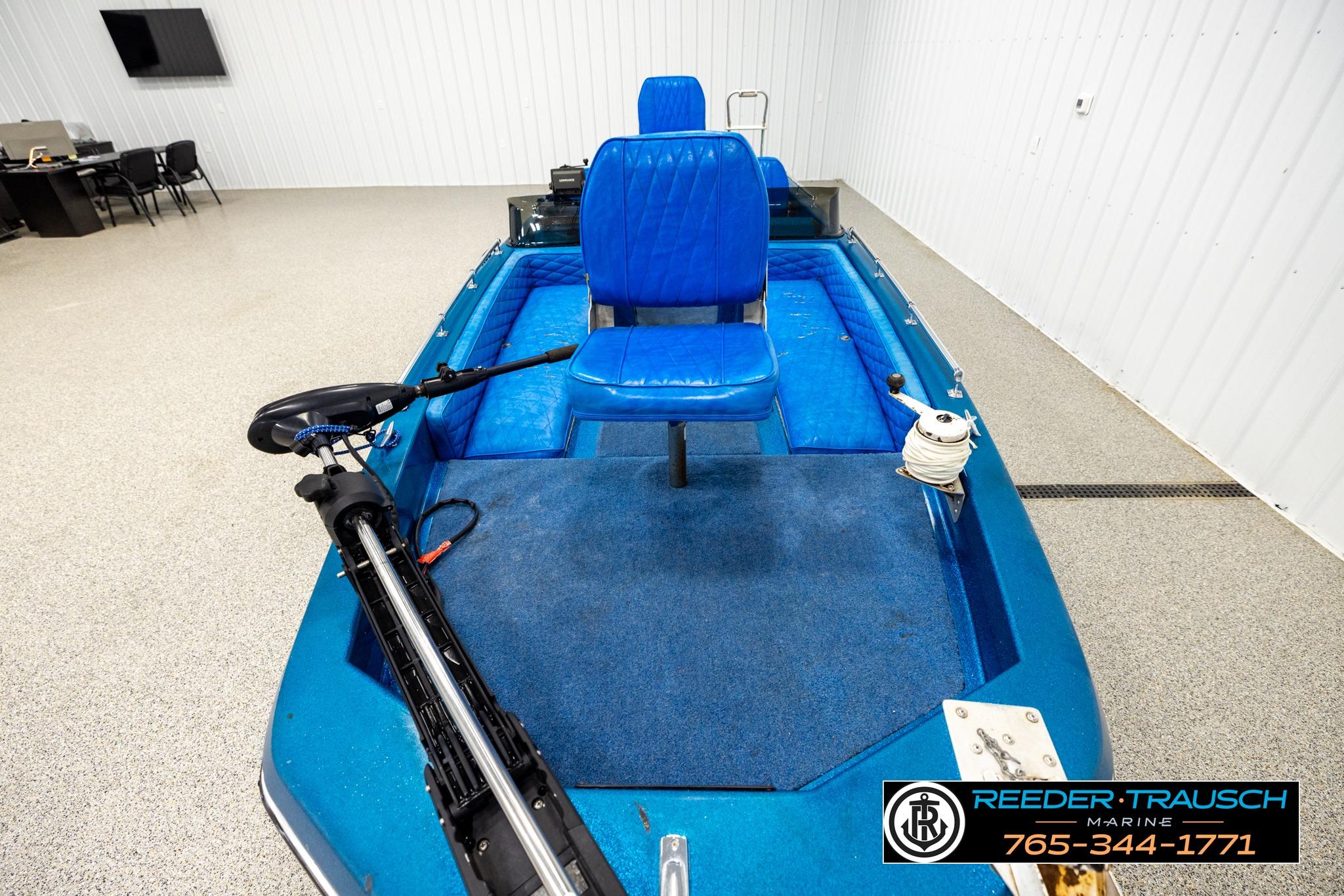 1980 Ranger 175 VS boat with blue seating and trolling motor in showroom.