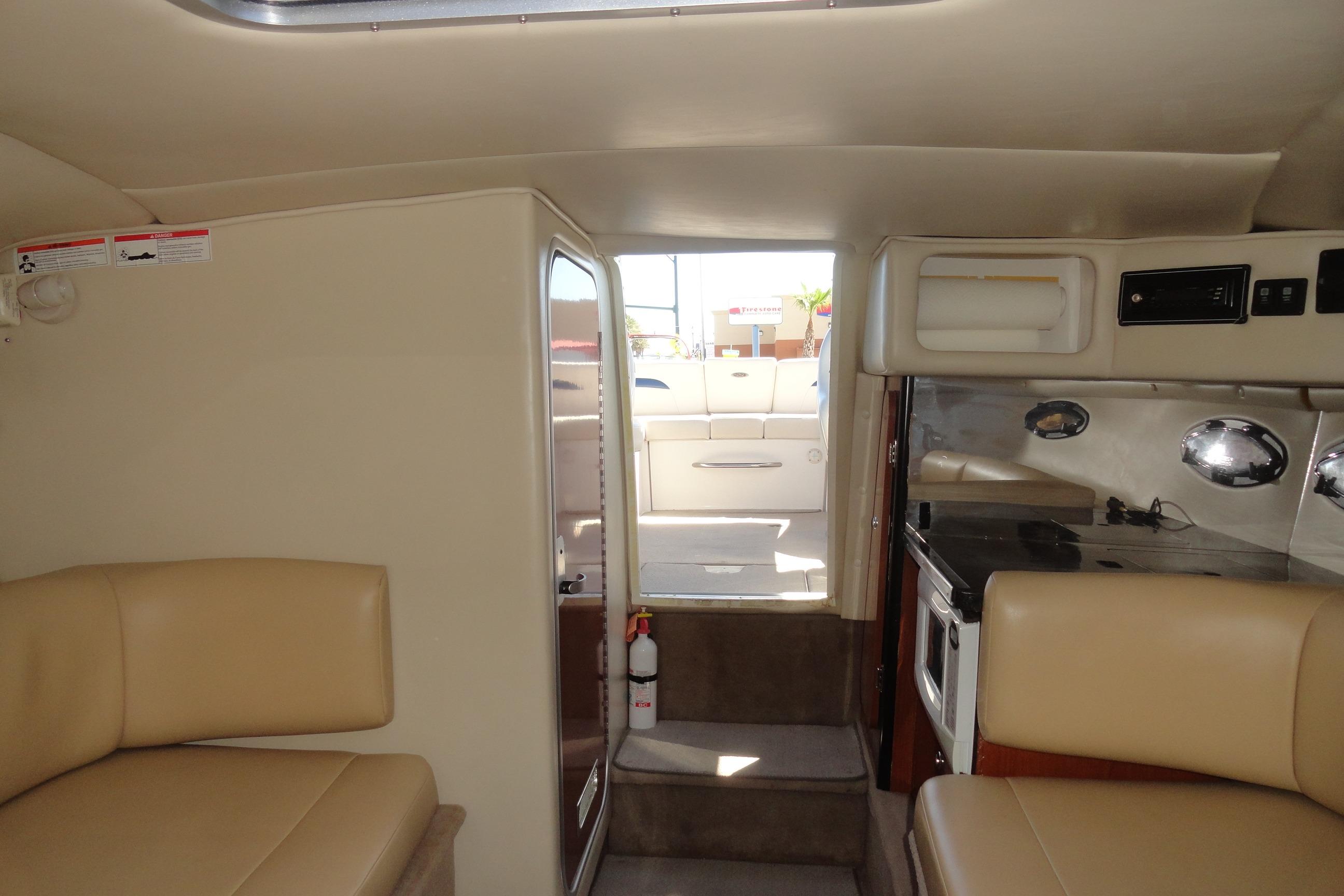 Interior of 2001 Chaparral 265 SSi boat with seating and kitchenette.
