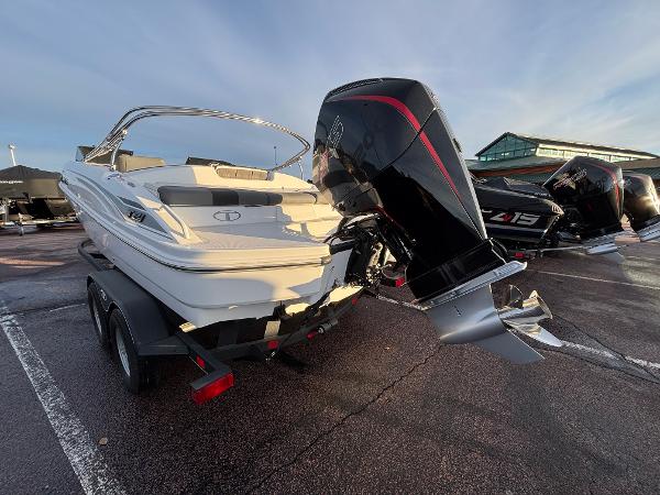 2024 Tahoe T21 boat with powerful outboard motor in a parking lot.