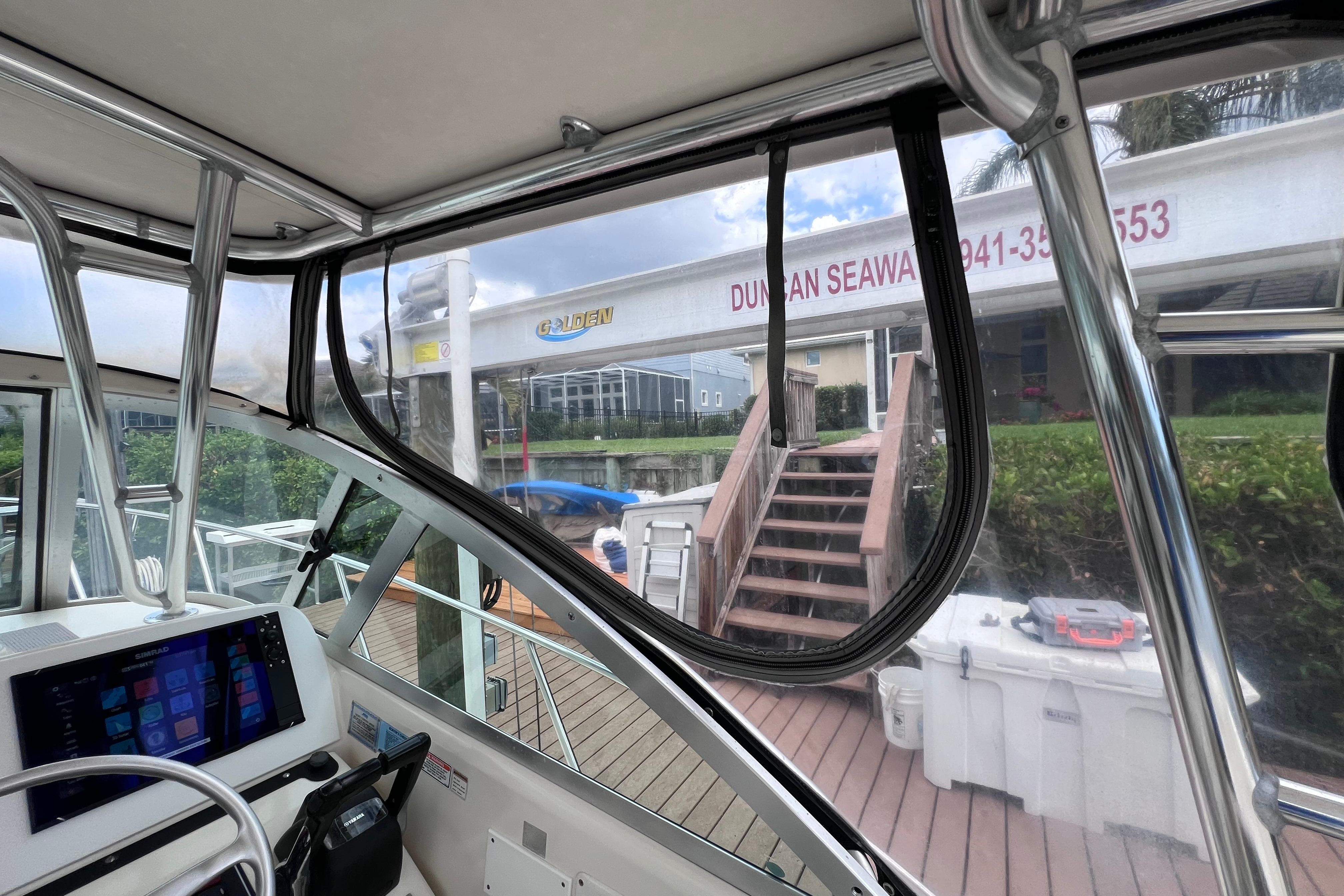 Interior view of a 2005 Pursuit 3070 Offshore boat docked at a marina.