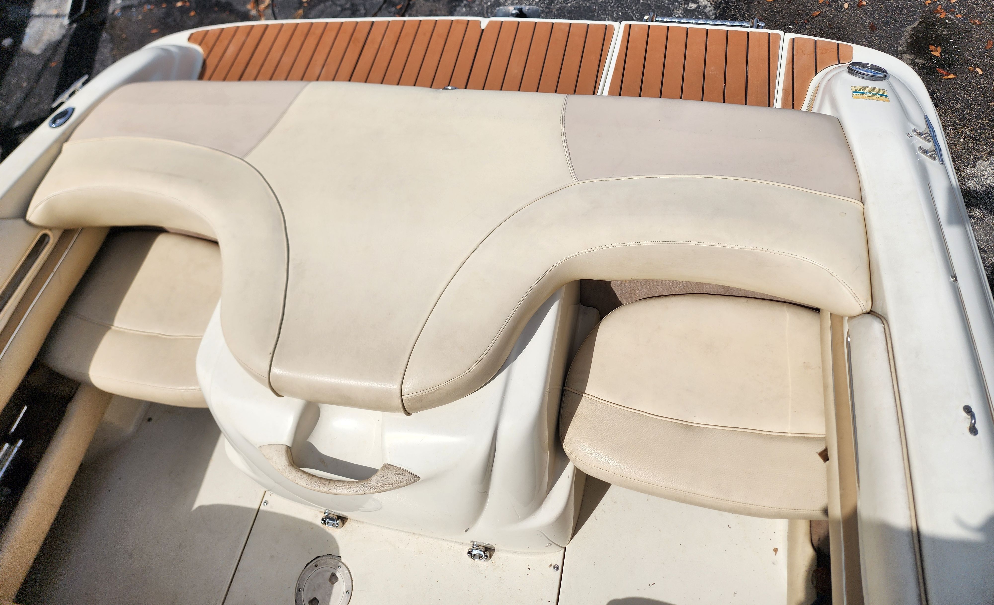The image shows the beige upholstery of a 1999 Sea Ray 210 Bowrider Signature.