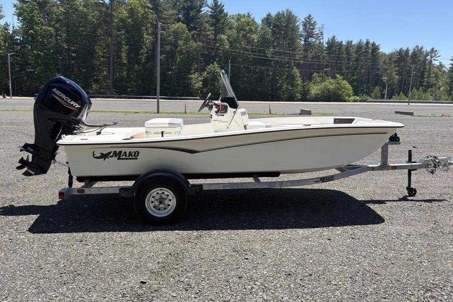 2026 Mako Pro Skiff 15 CC boat on trailer, parked outdoors.