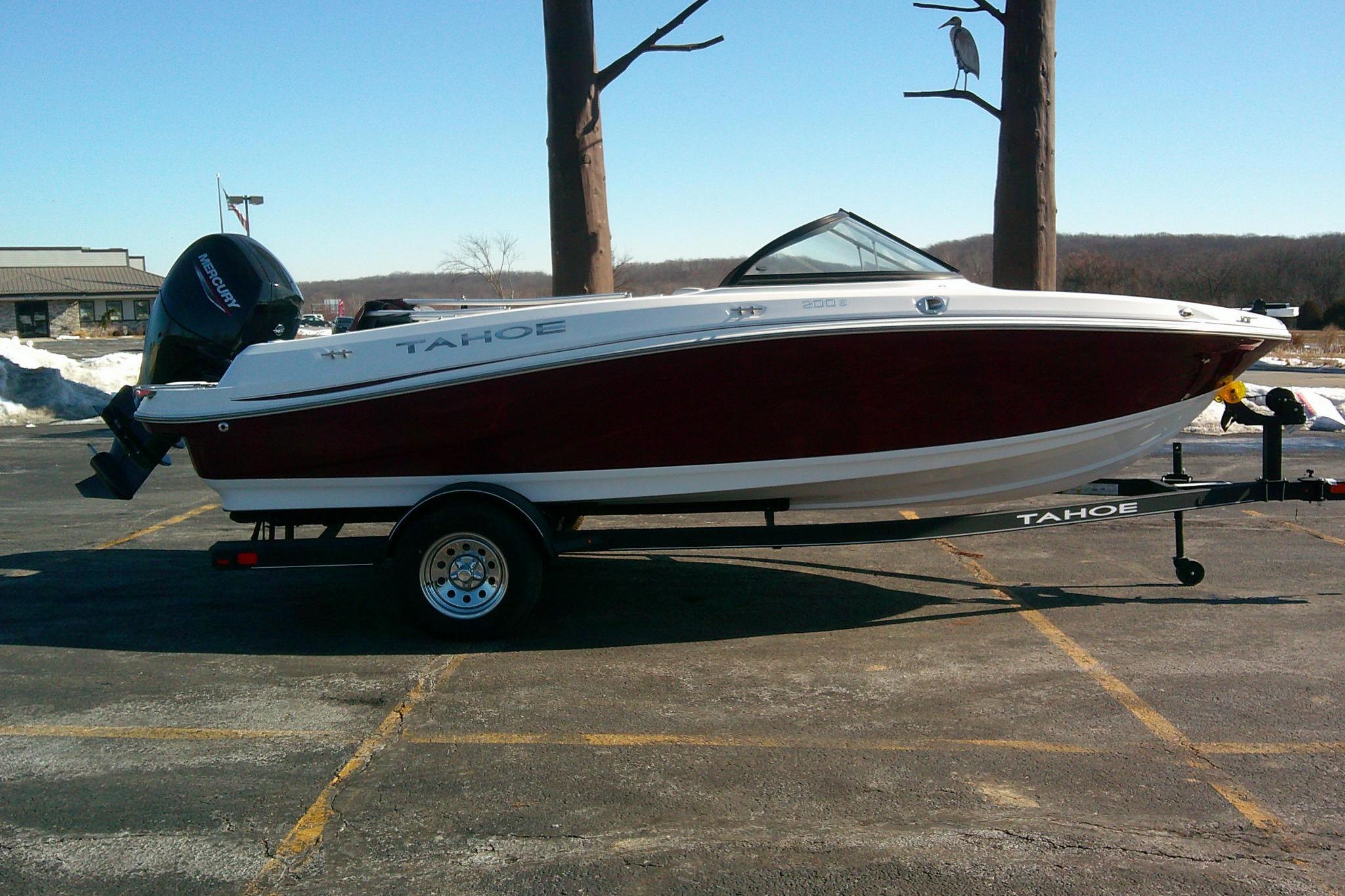 2024 Tahoe 200 S boat on trailer in parking lot, side view.