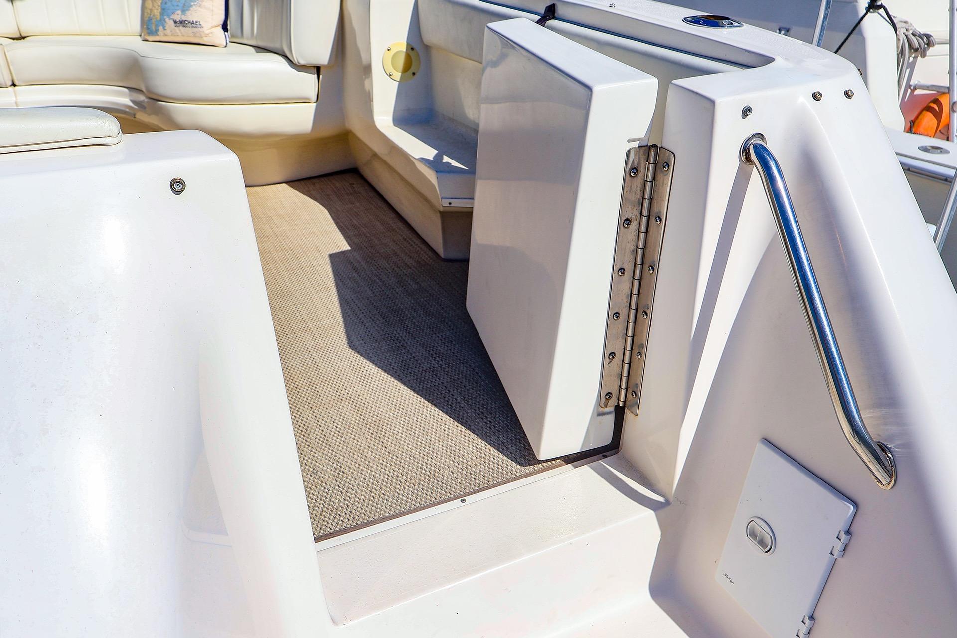 1998 Sea Ray 500 Sundancer yacht interior with seating and carpeted floor.