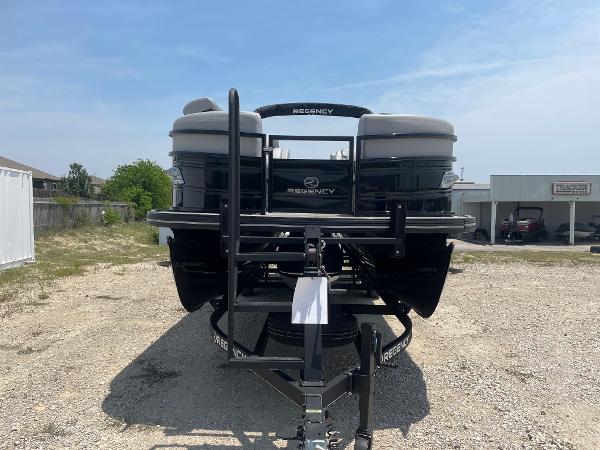 2023 Regency 250 LE3 pontoon boat on trailer, parked outdoors.
