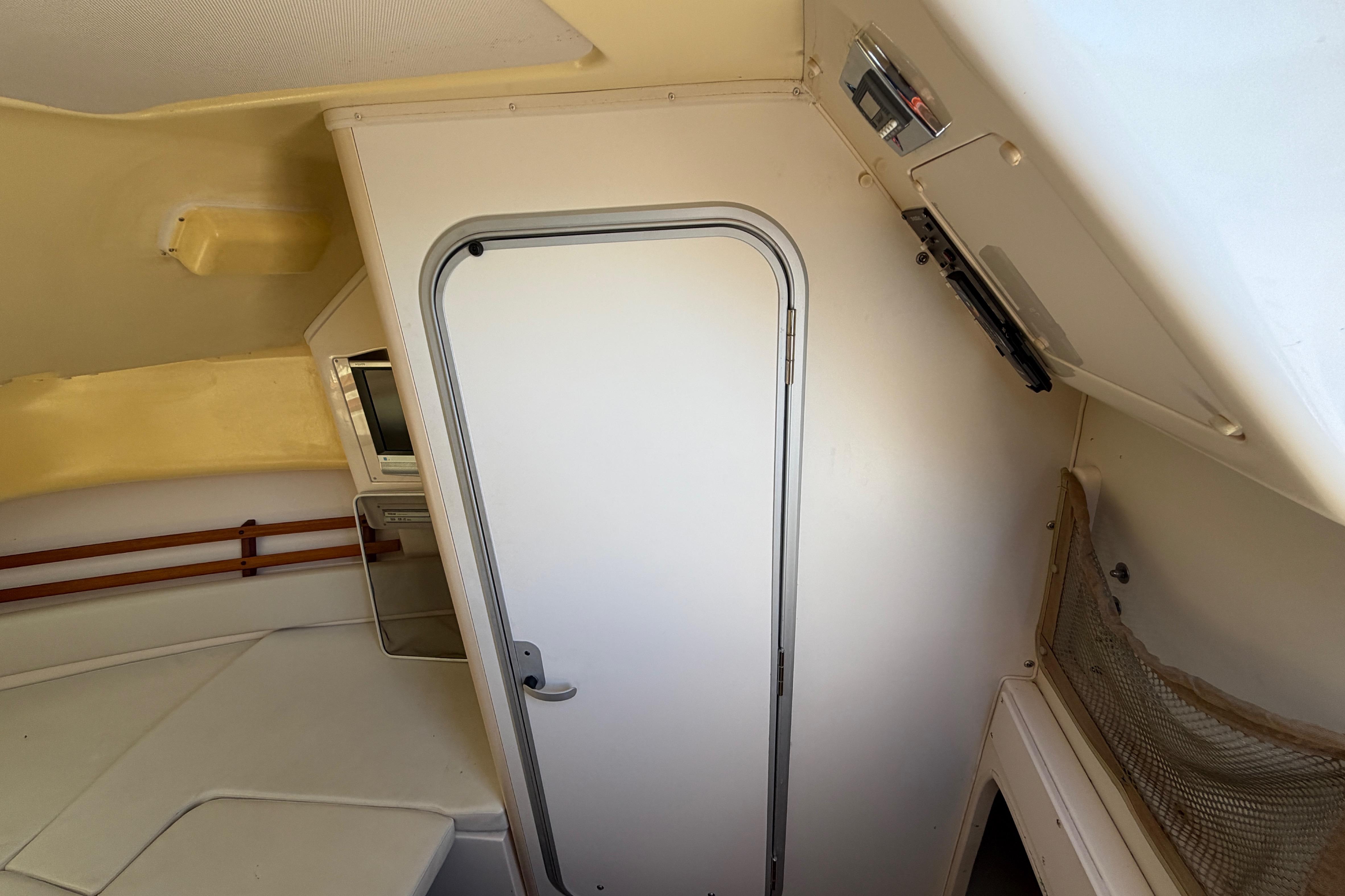 Interior cabin of 2006 Grady-White Sailfish 282 boat, featuring a door and seating area.