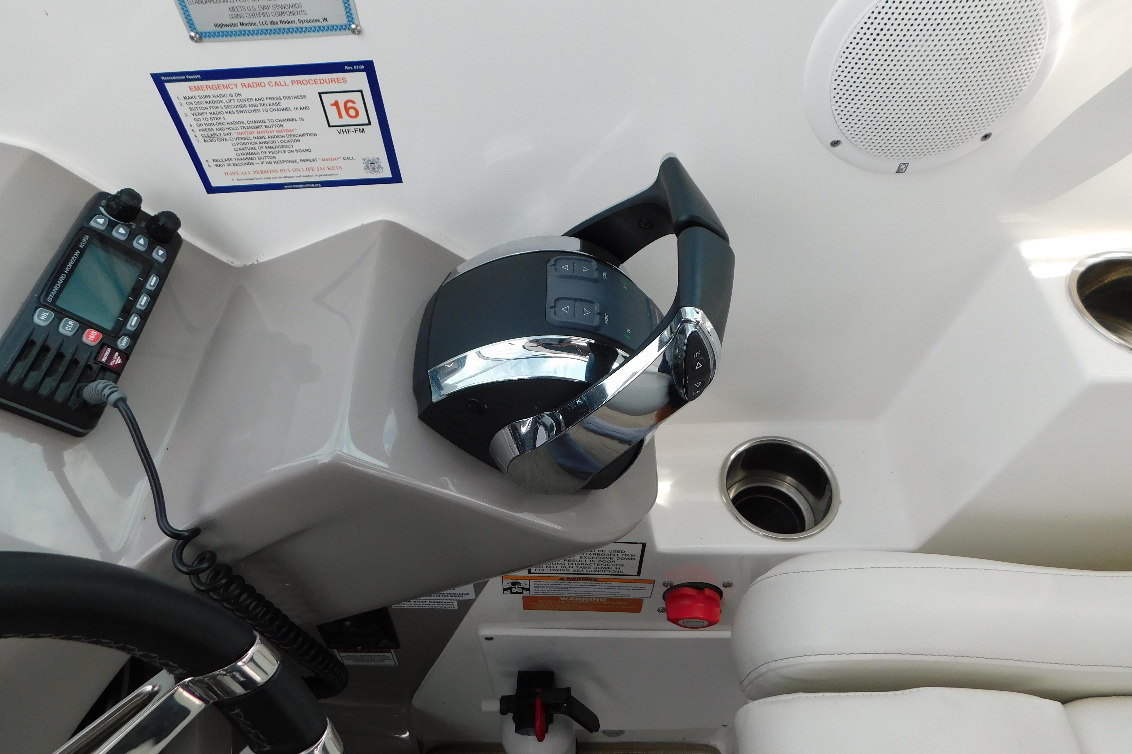 2017 Rinker EX 320 boat helm with controls, radio, and speaker.