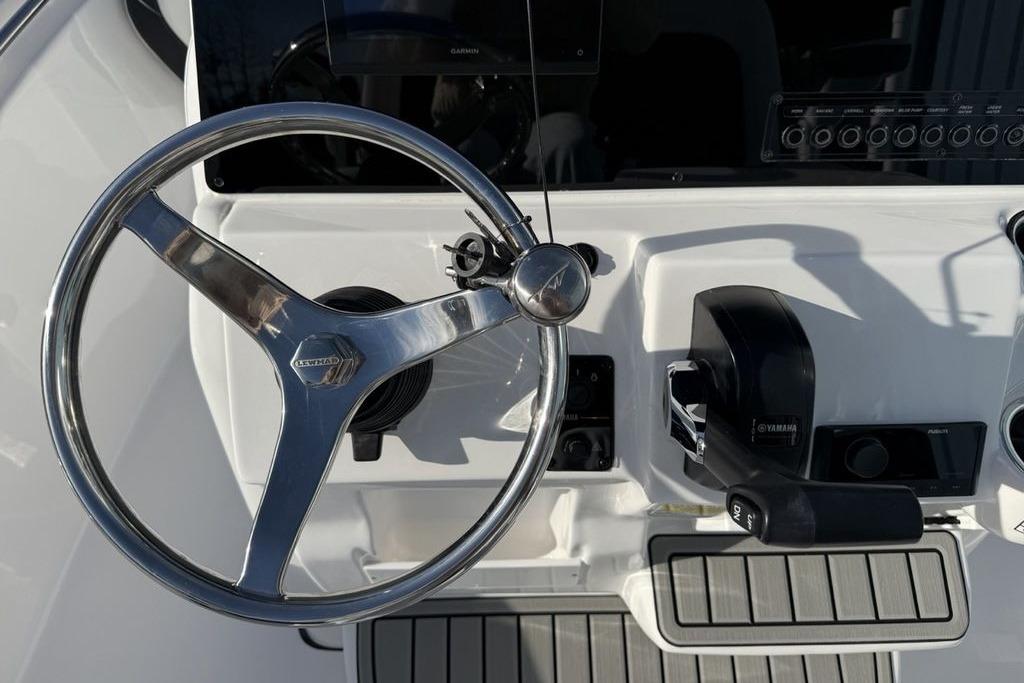 Steering wheel and controls of 2026 Tidewater 198 CC Adventure boat.