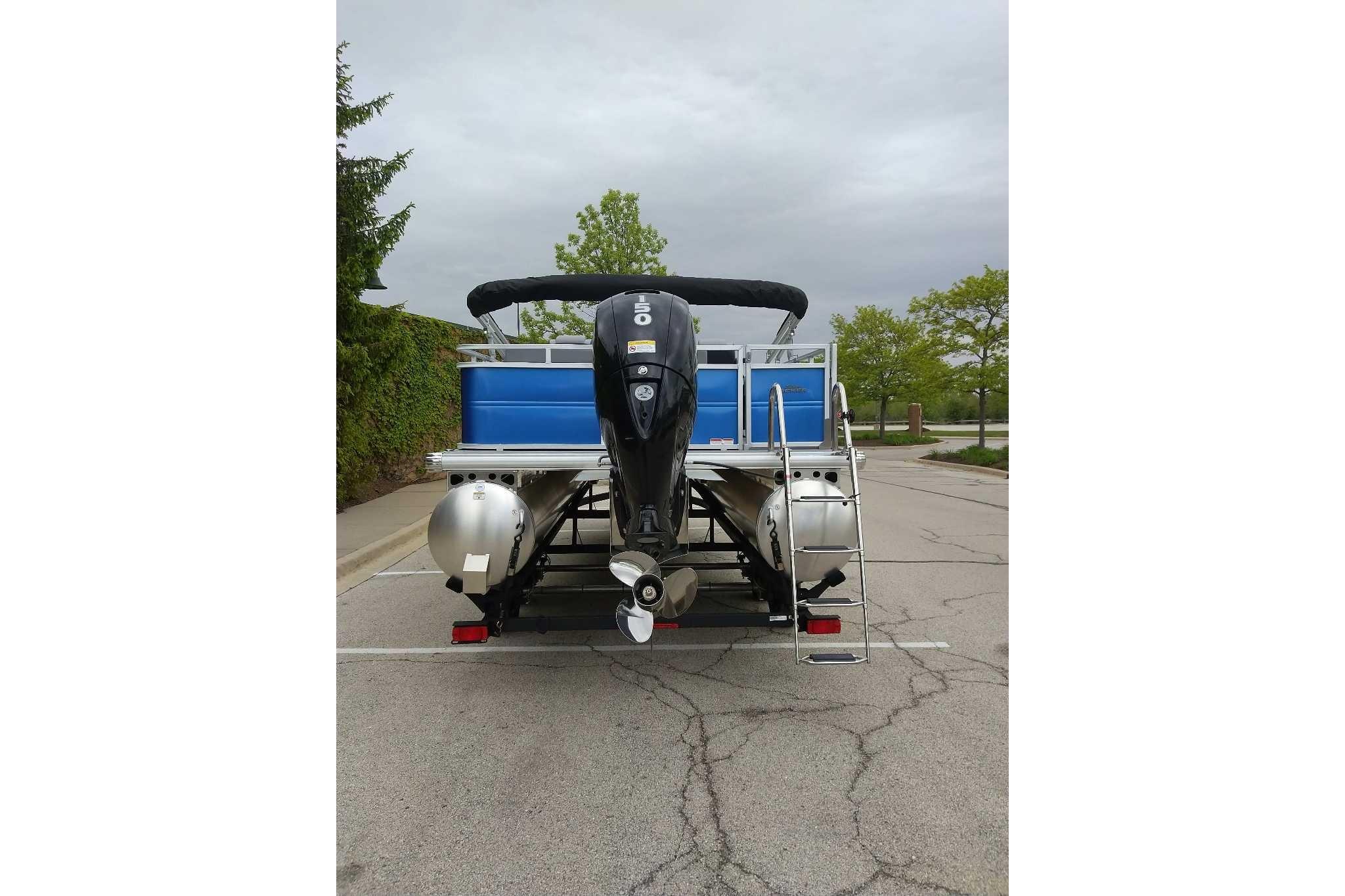 2026 Sun Tracker Party Barge 22 RF DLX pontoon boat, rear view with motor and ladder.