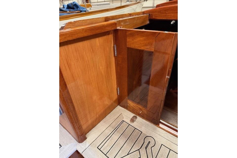 Wooden interior of 2010 Spirit Yachts R46, featuring polished cabinetry and flooring.