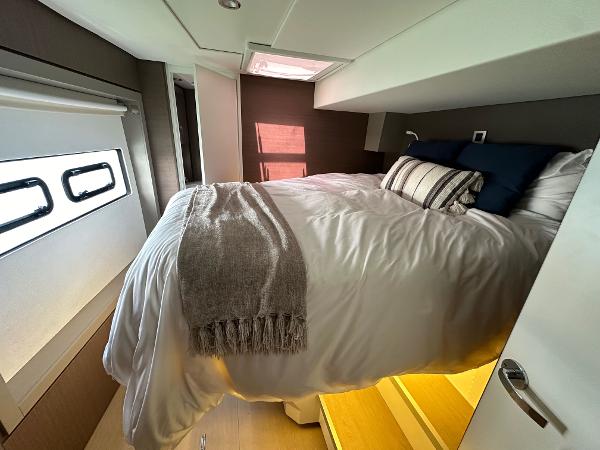 Cozy bedroom in 2021 Bali 4.8 yacht with modern decor and natural light.