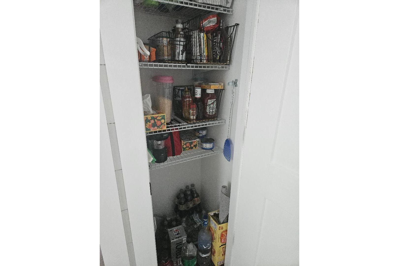Pantry shelves with assorted food items and beverages on an East Coast Houseboats Freedom 40.